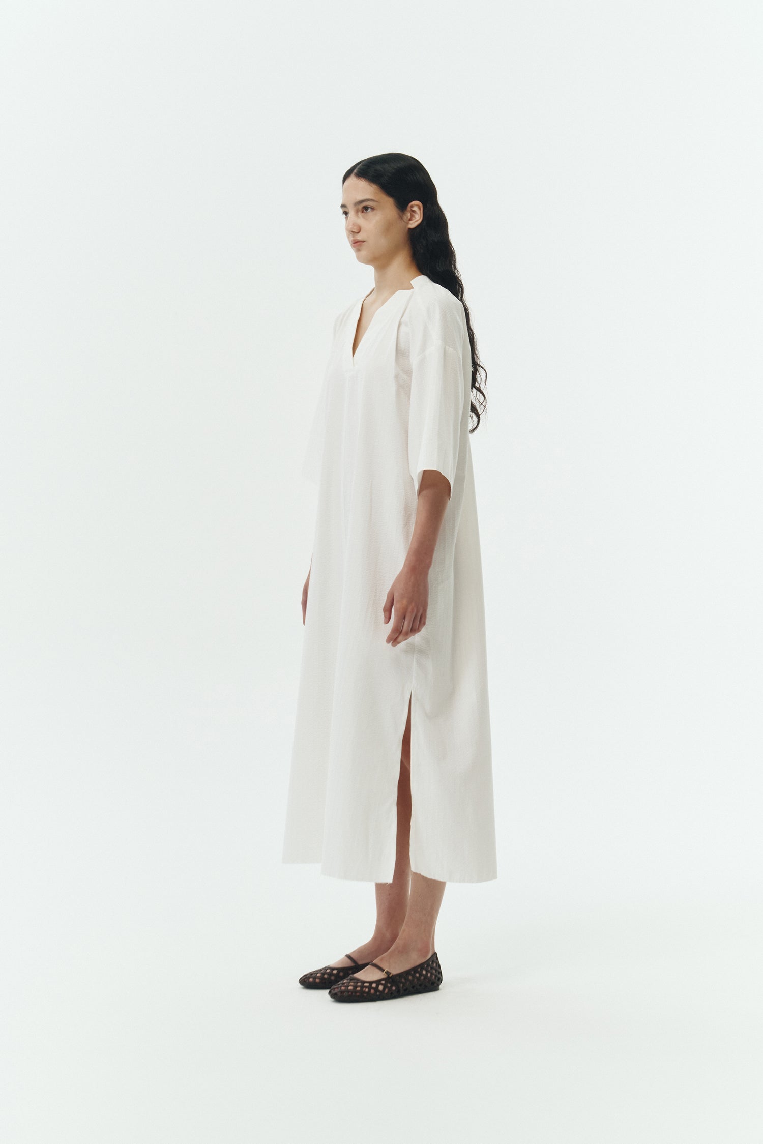 Charlotte Dress in white stripe, V-neck summer maxi dress in a lightweight linen-rayon blend with drop shoulders, hidden side pockets, raw edge hem, and a relaxed fit.