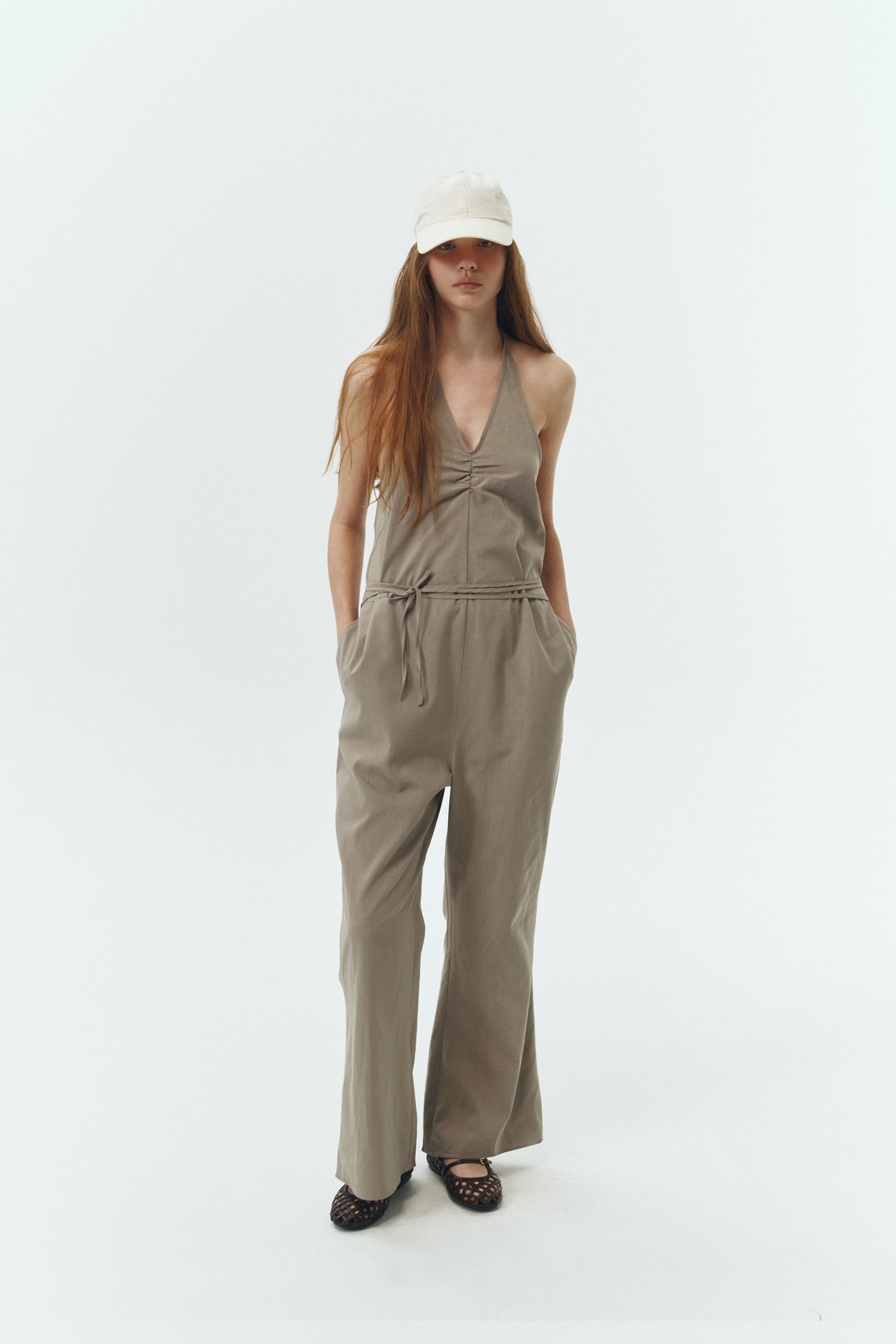Daisy Jumpsuit in khaki gray, sleeveless linen blend jumpsuit with adjustable halterneck, open back, straight-leg silhouette, and relaxed fit.