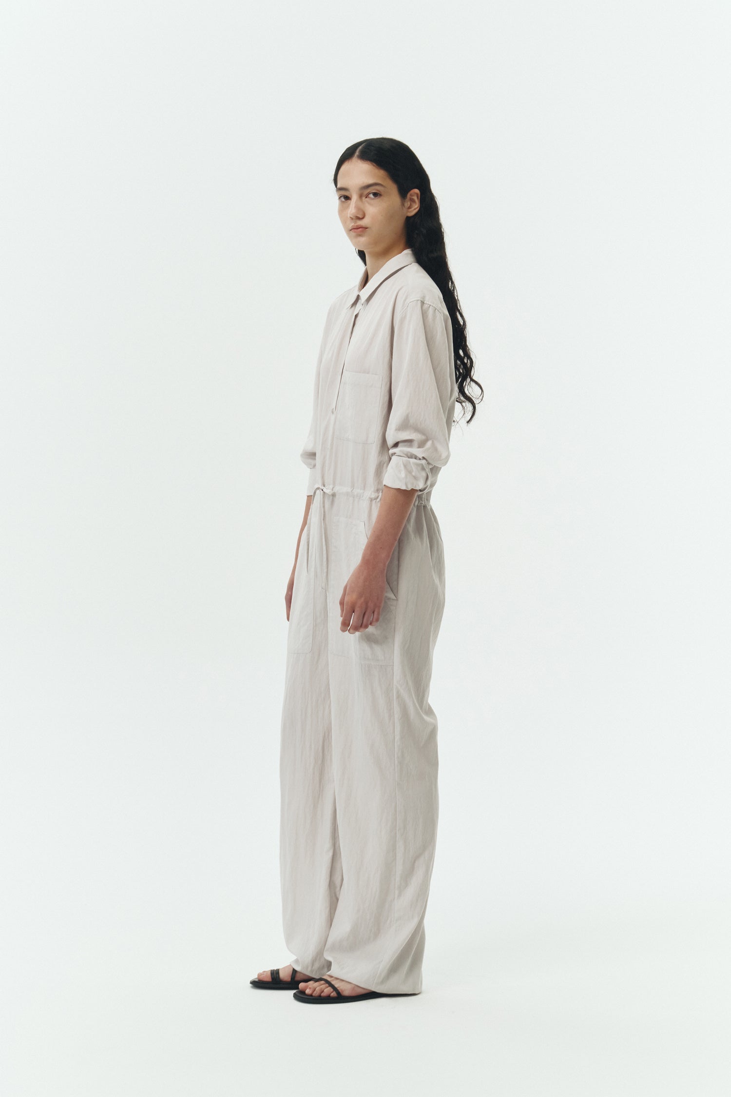 Saige Jumpsuit in cloud, long-sleeve rayon blend jumpsuit with point collar, front button closure, drawstring waist, and patch pockets.