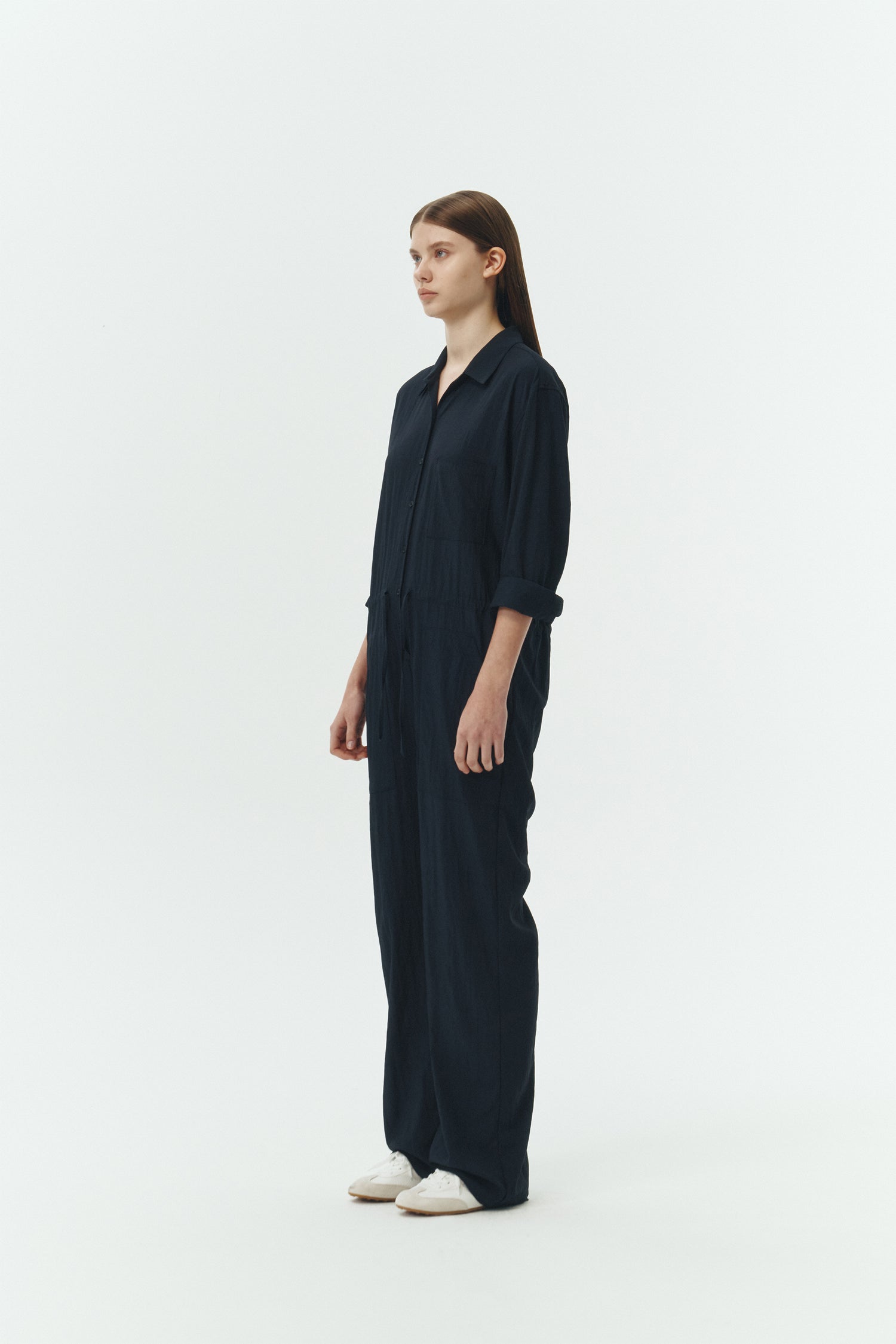 Saige Jumpsuit in navy, long-sleeve rayon blend jumpsuit with point collar, front button closure, drawstring waist, and patch pockets