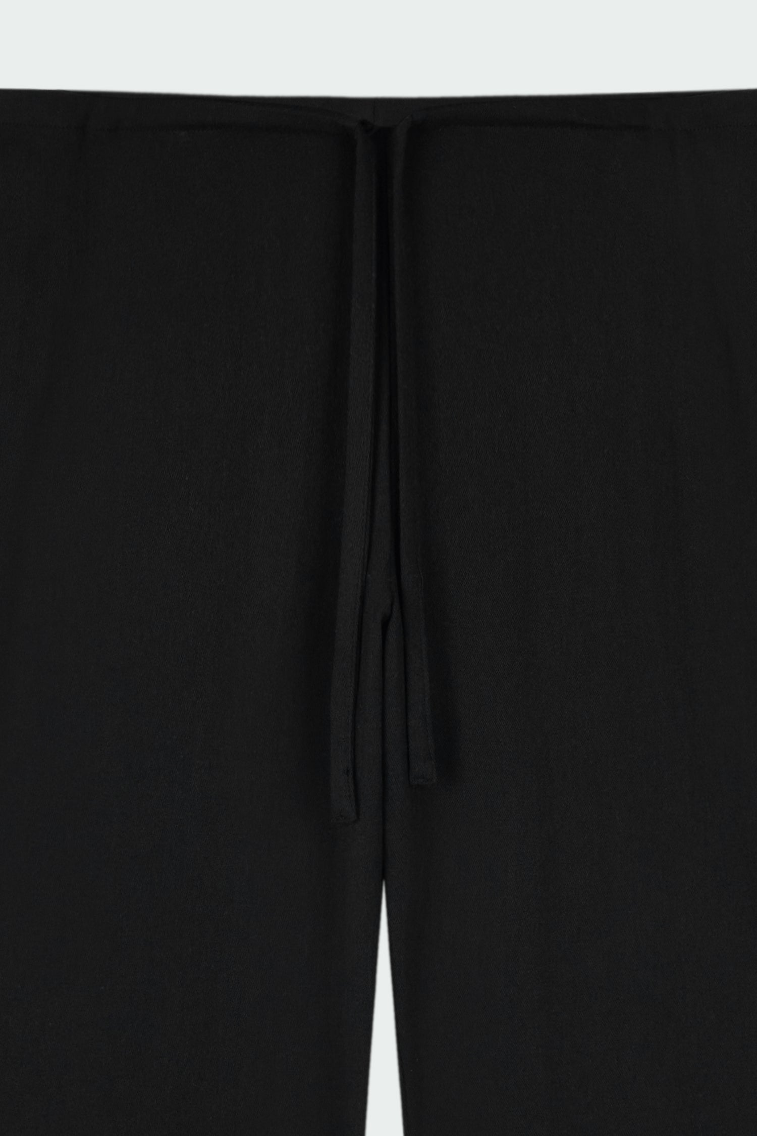 Chloe Pants in black, lightweight cotton pants with a drawstring waist, side pockets, and a flared bottom, relaxed fit for effortless everyday wear