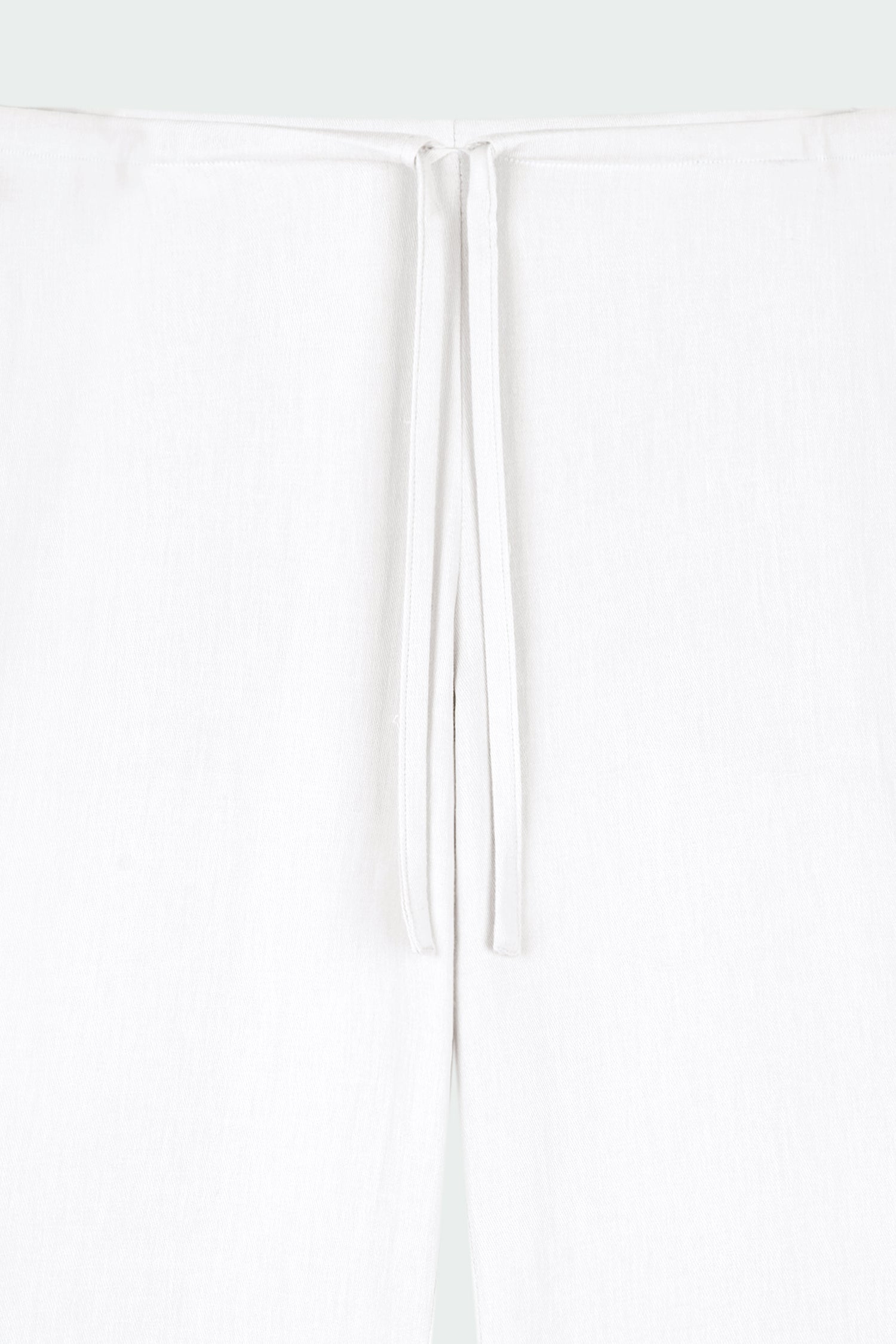 Chloe Pants in off white, lightweight cotton pants with a drawstring waist, side pockets, and a flared bottom, relaxed fit for effortless everyday wear