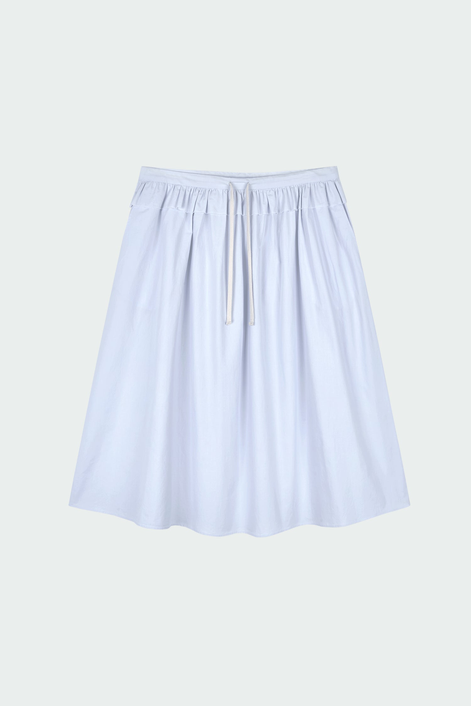 Maryam Skirt in sky, a midi cotton skirt with shirred waistband, drawstring detail, side pockets, and a softly flared silhouette