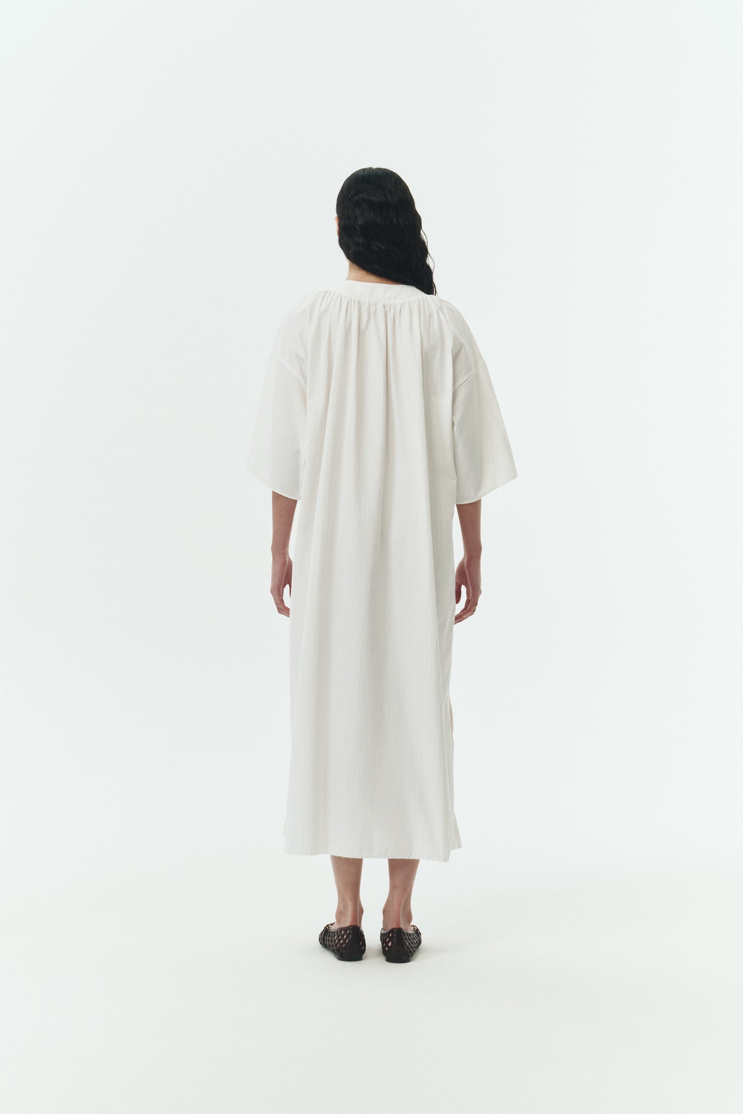 Charlotte Dress in white stripe, V-neck summer maxi dress in a lightweight linen-rayon blend with drop shoulders, hidden side pockets, raw edge hem, and a relaxed fit.