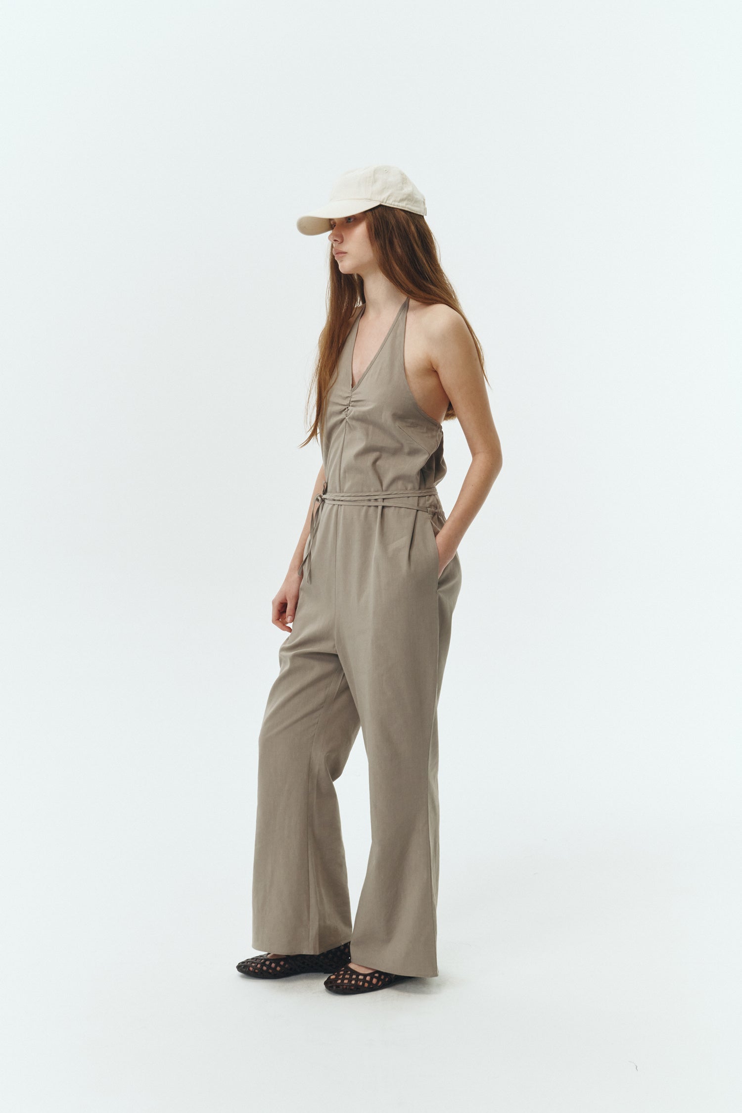 Daisy Jumpsuit in khaki gray, sleeveless linen blend jumpsuit with adjustable halterneck, open back, straight-leg silhouette, and relaxed fit.
