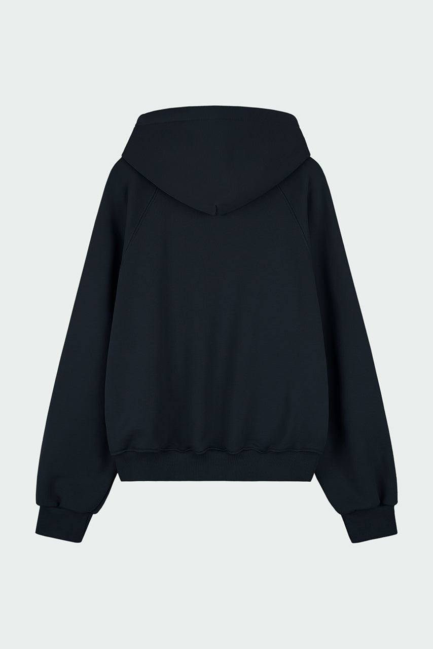 Kaia Hoodie in navy, oversized cotton French terry pullover with drawstring hood, raglan sleeves, kangaroo pocket, and ribbed trims.