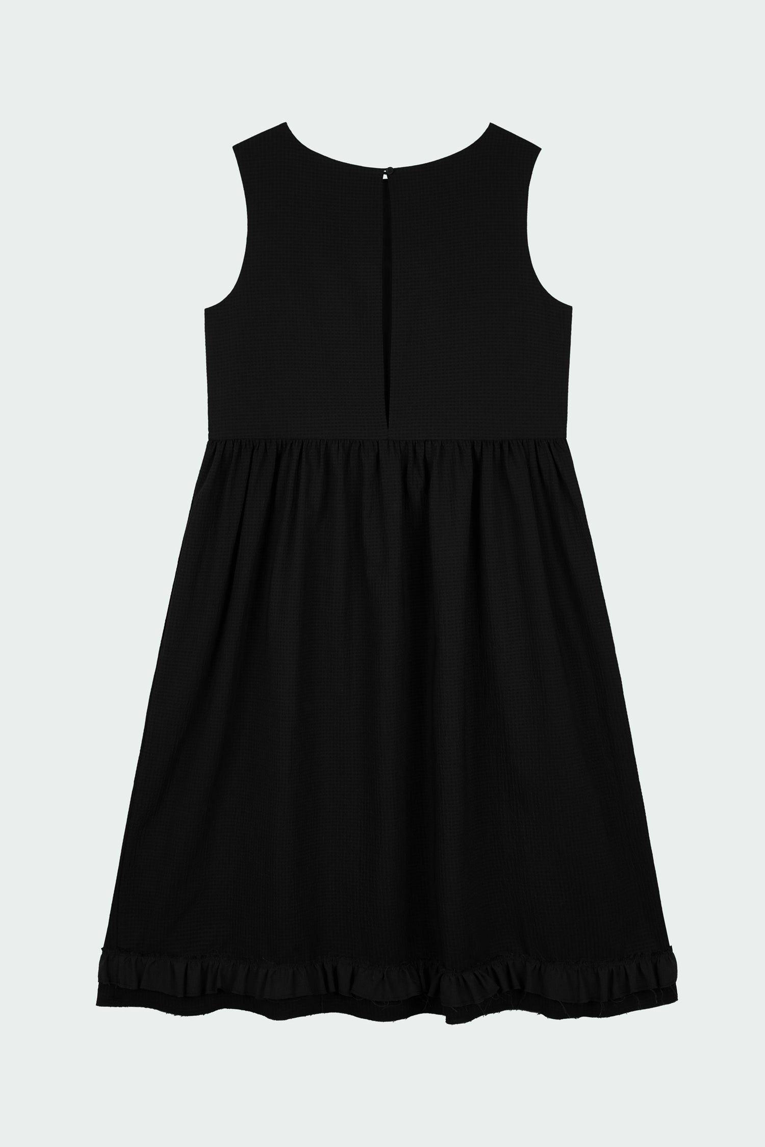 Pina Dress in black, sleeveless cotton midi dress with shirring at waist and hem, hidden side pockets, and an open back with button closure.