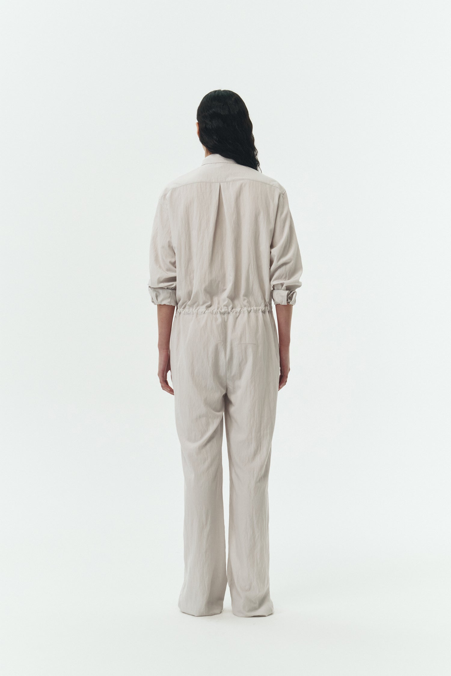 Saige Jumpsuit in cloud, long-sleeve rayon blend jumpsuit with point collar, front button closure, drawstring waist, and patch pockets.