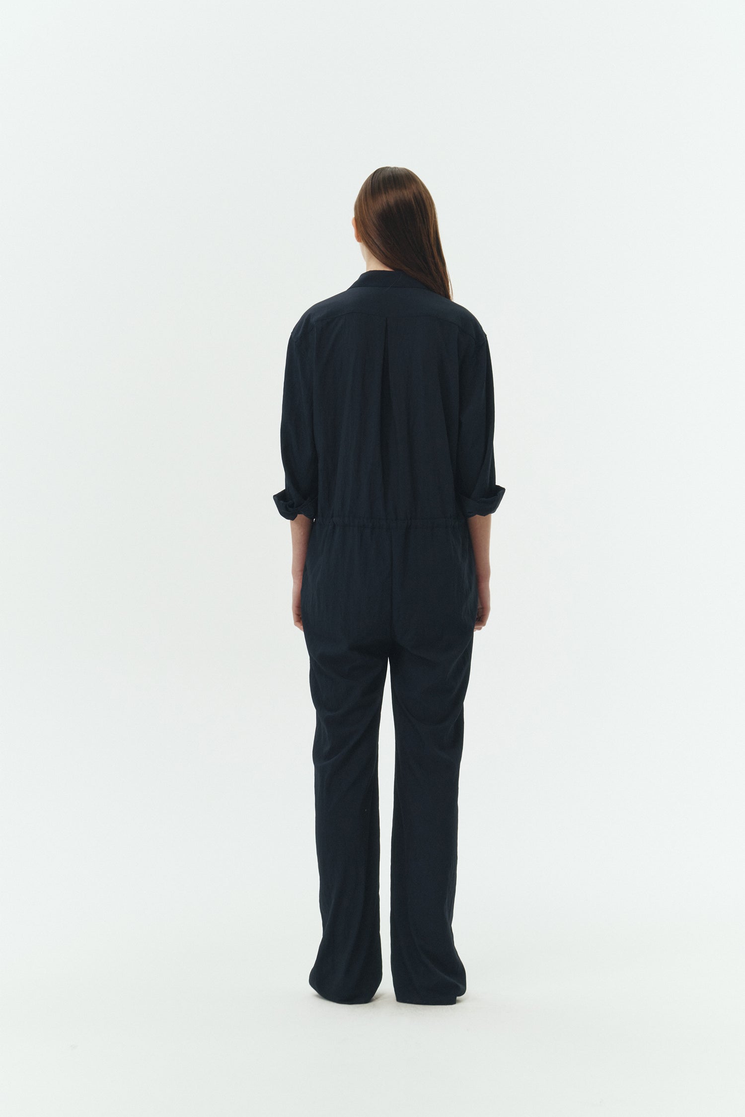 Saige Jumpsuit in navy, long-sleeve rayon blend jumpsuit with point collar, front button closure, drawstring waist, and patch pockets