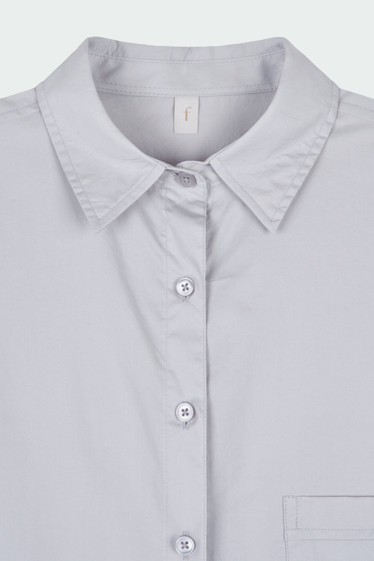 Cara Dress in cloud gray, long sleeve cotton shirt dress with front chest pocket, curved hem, hidden side pockets, and a relaxed silhouette.