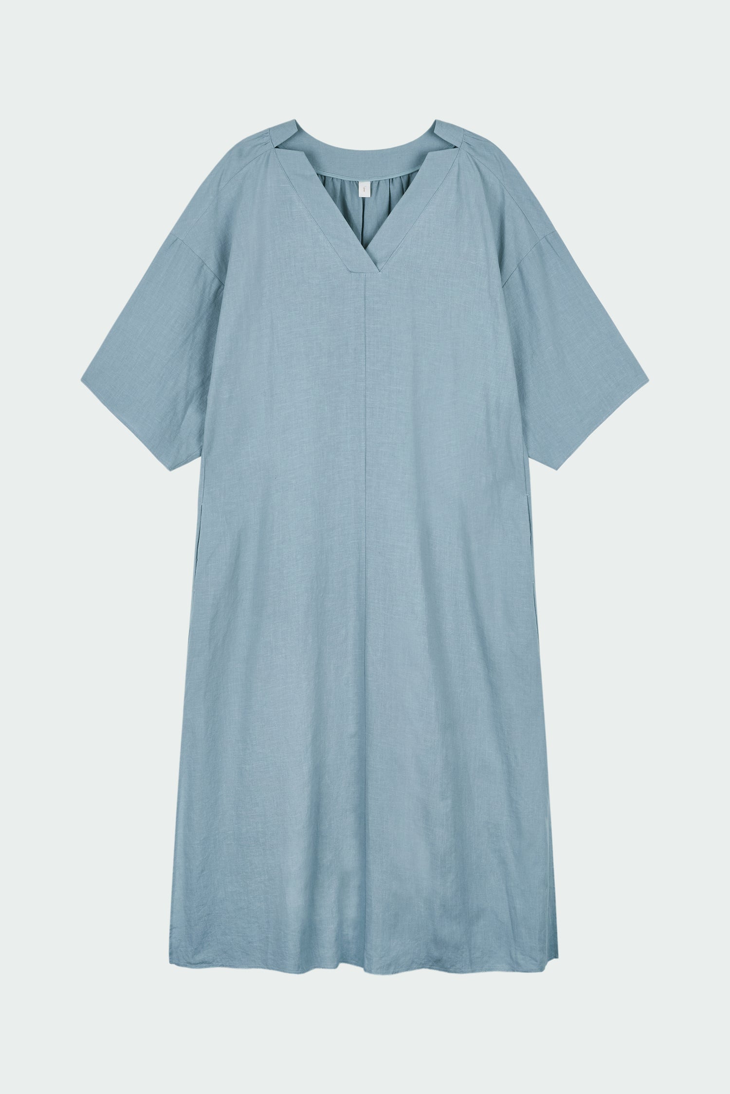 Charlotte Dress in light blue, V-neck summer maxi dress in a lightweight linen-rayon blend with drop shoulders, hidden side pockets, raw edge hem, and a relaxed fit.
