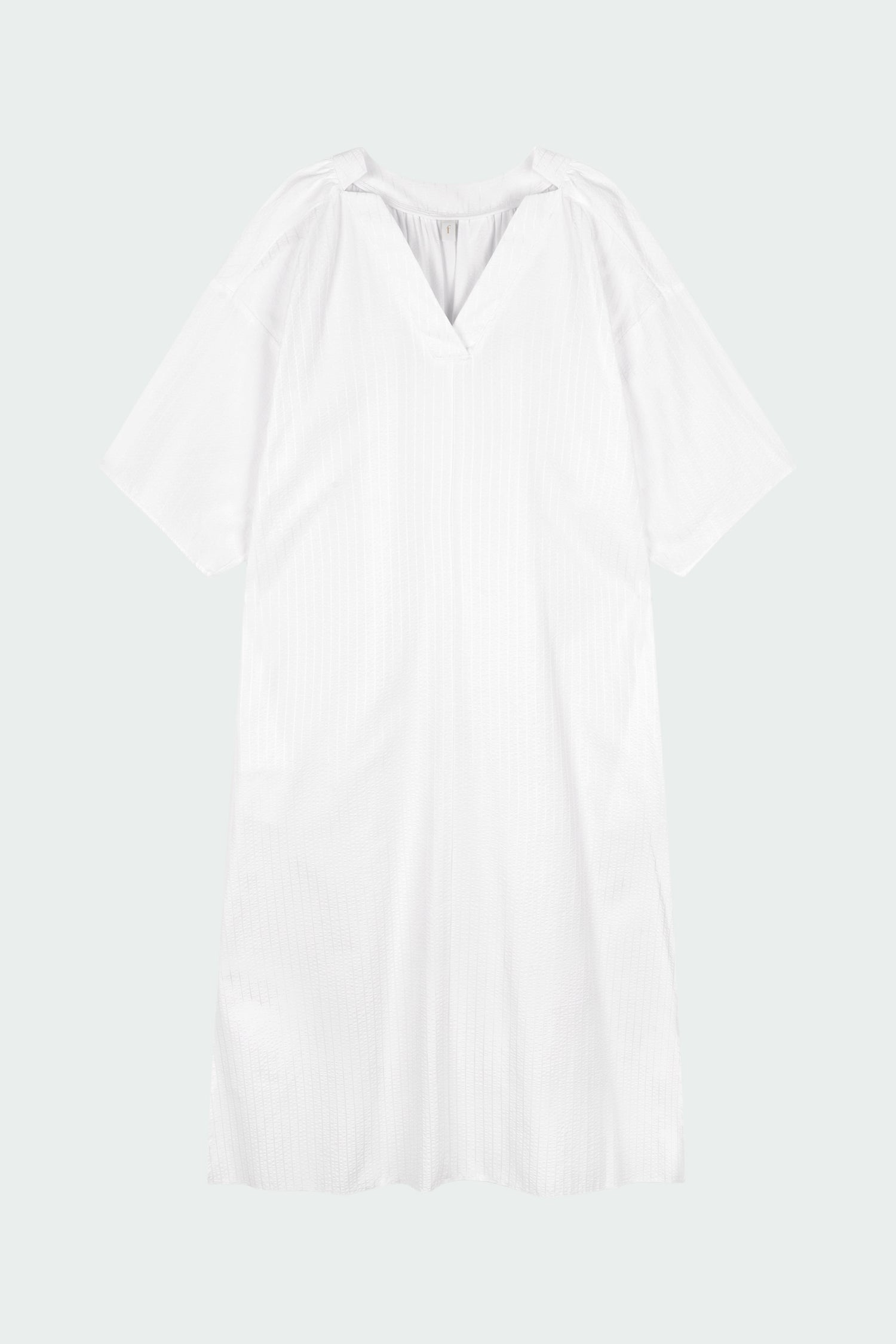 Charlotte Dress in white stripe, V-neck summer maxi dress in a lightweight linen-rayon blend with drop shoulders, hidden side pockets, raw edge hem, and a relaxed fit.