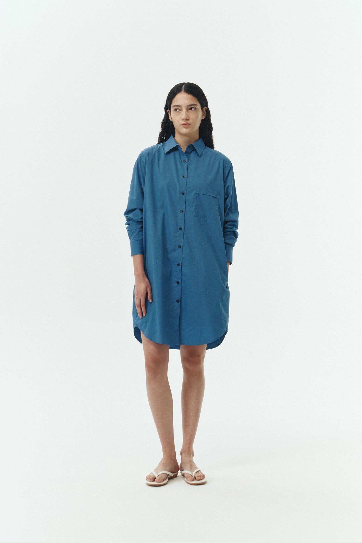 Cara Dress in blue green, long sleeve cotton shirt dress with front chest pocket, curved hem, hidden side pockets, and a relaxed silhouette.