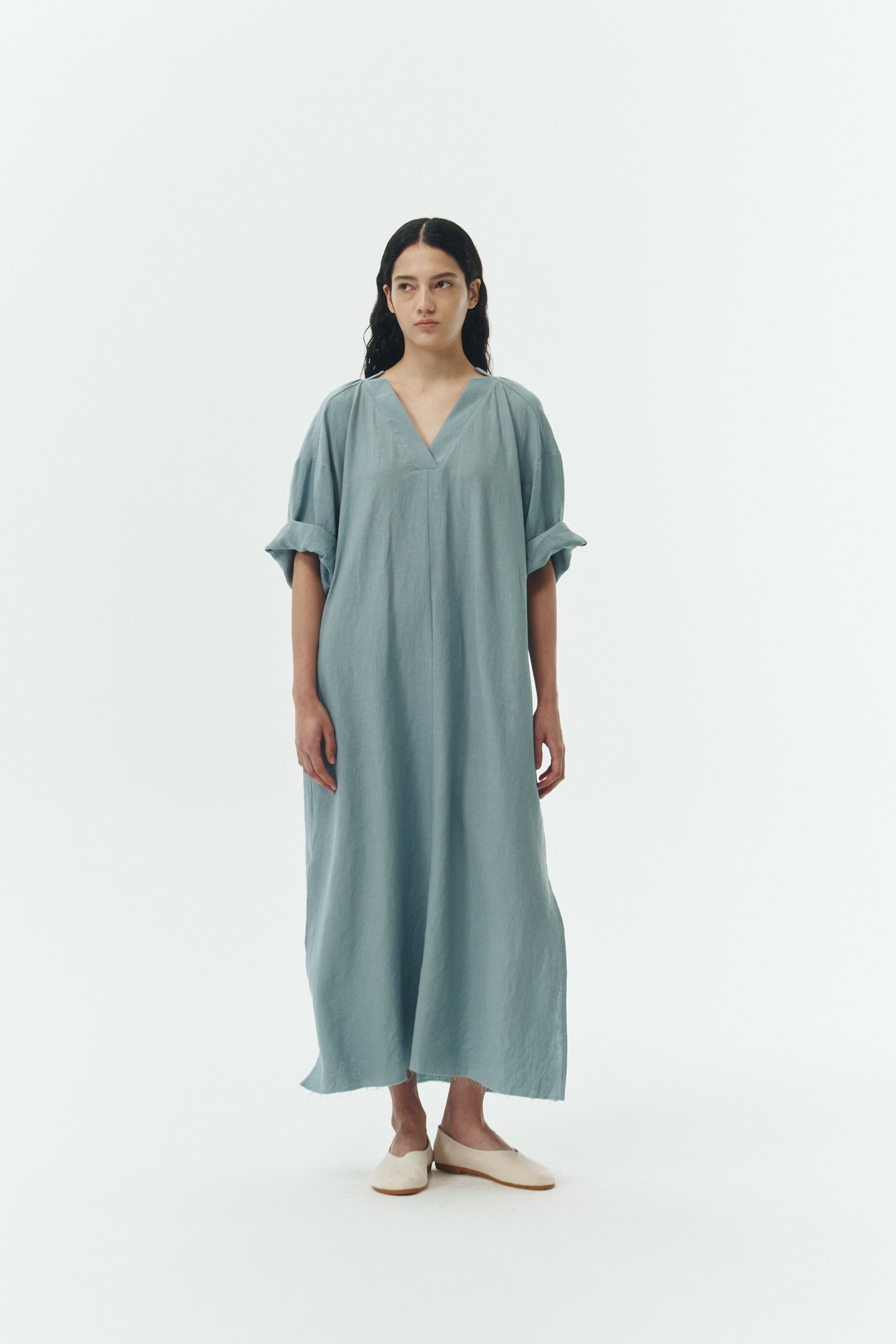 Charlotte Dress in light blue, V-neck summer maxi dress in a lightweight linen-rayon blend with drop shoulders, hidden side pockets, raw edge hem, and a relaxed fit.