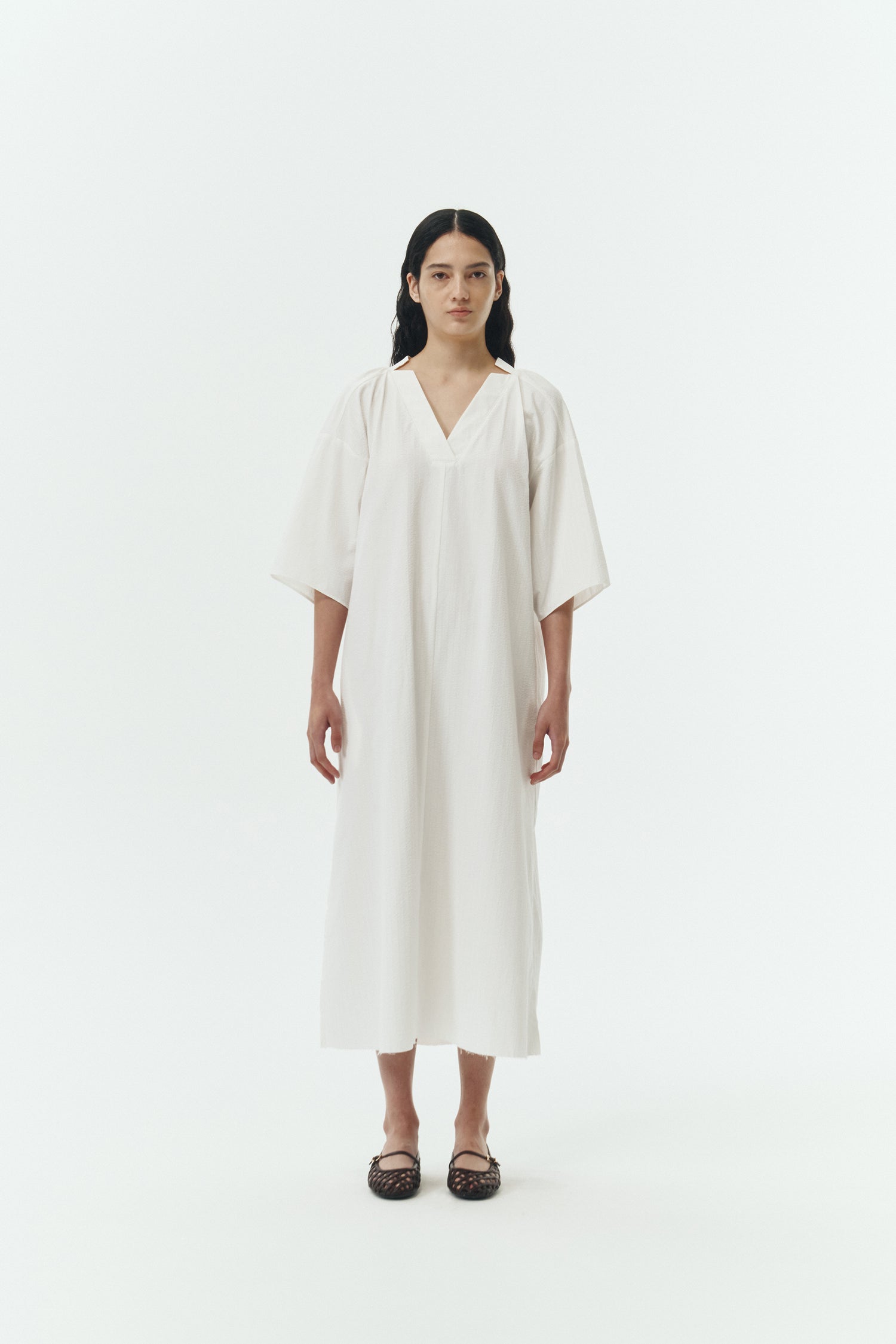 Charlotte Dress in white stripe, V-neck summer maxi dress in a lightweight linen-rayon blend with drop shoulders, hidden side pockets, raw edge hem, and a relaxed fit.