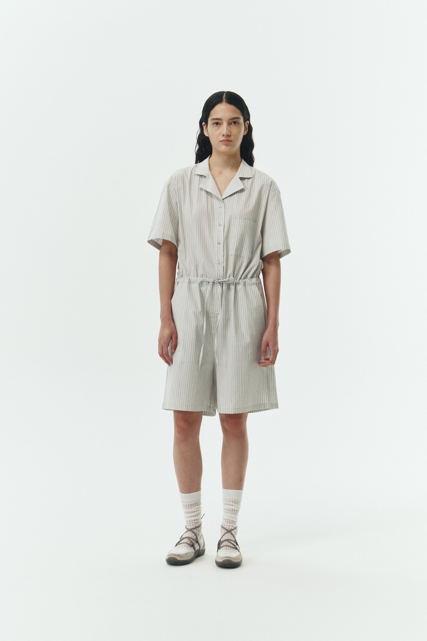 Emma Jumpsuit in stripe, short-sleeve cotton jumpsuit with camp collar, front buttons, drawstring waist, and multiple pockets.
