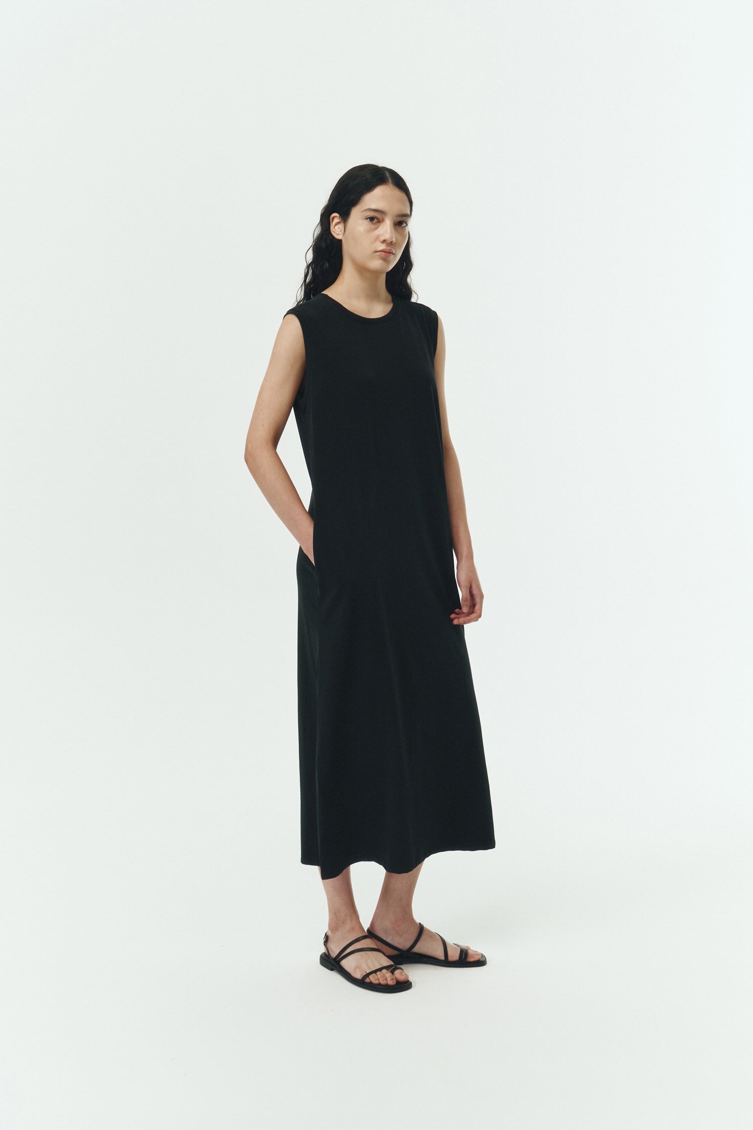 Jade Dress in black, a sleeveless knit cotton midi dress with side pockets, designed for breathable summer comfort