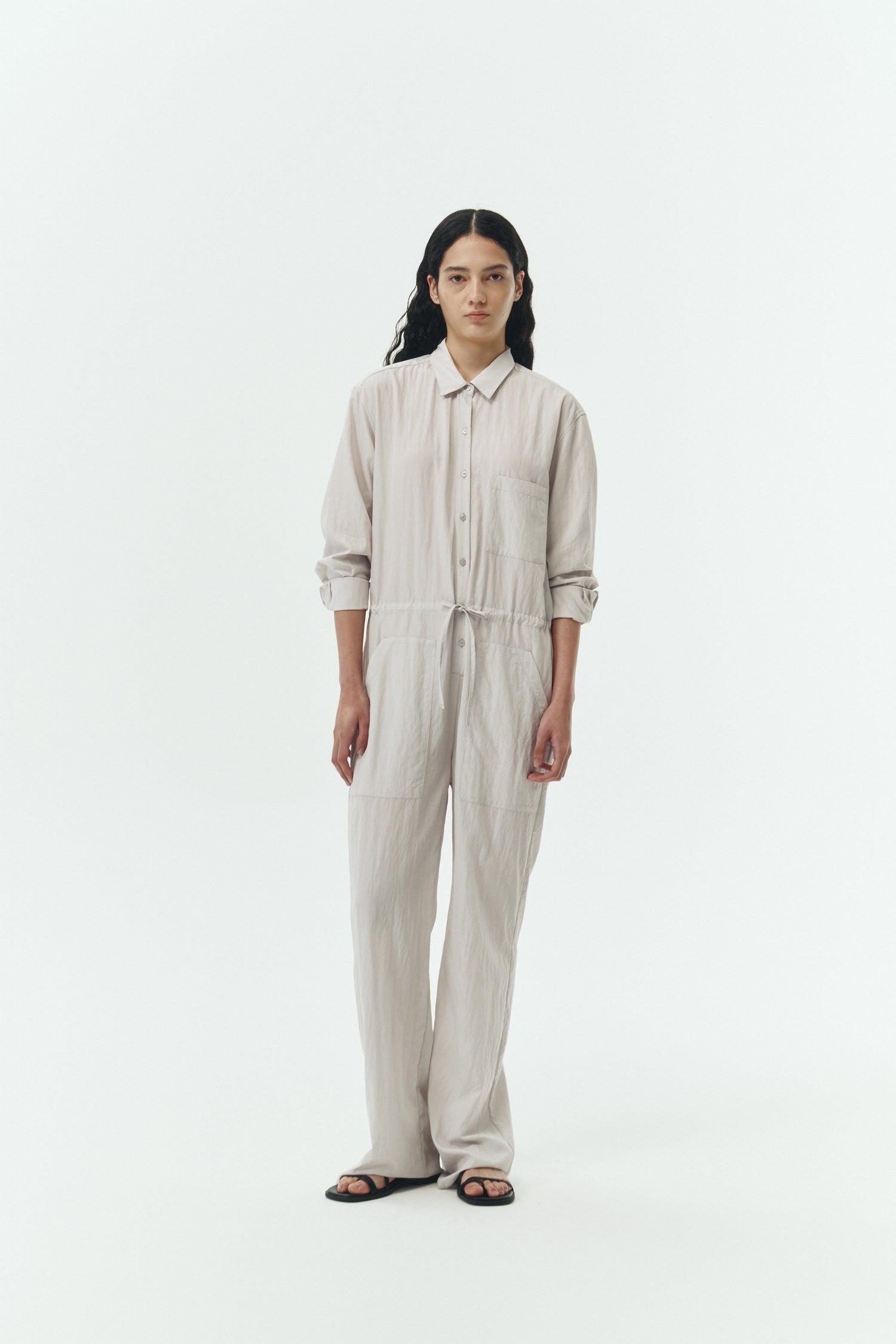 Saige Jumpsuit in cloud, long-sleeve rayon blend jumpsuit with point collar, front button closure, drawstring waist, and patch pockets.