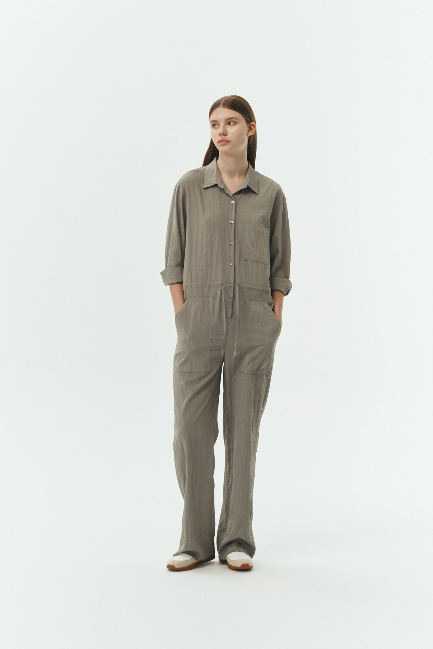 Saige Jumpsuit in khaki gray, long-sleeve rayon blend jumpsuit with point collar, front button closure, drawstring waist, and patch pockets.