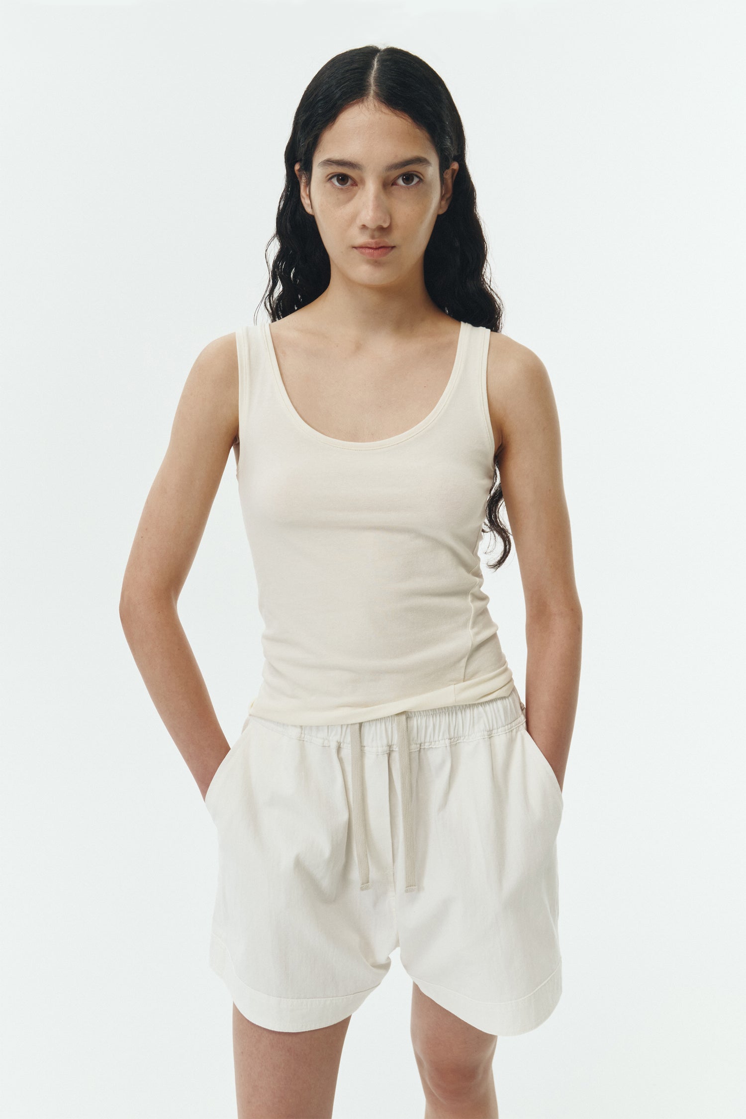 Zoe Tank Top in cream, slim-fit stretch cotton tank with scooped neckline and diagonal seam detail for a sleek and minimal silhouette.