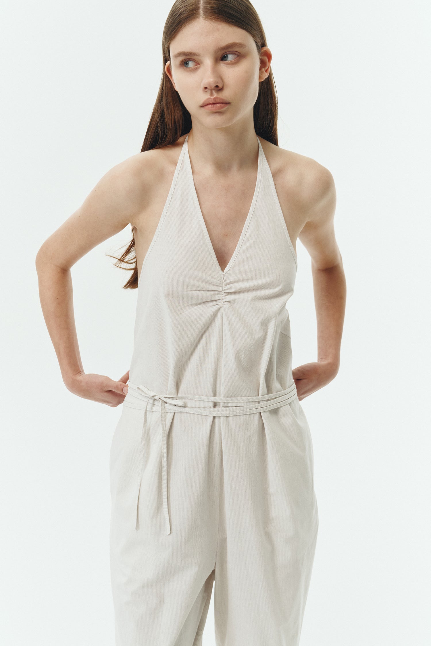 Daisy Jumpsuit in stripe, sleeveless linen blend jumpsuit with adjustable halterneck, open back, straight-leg silhouette, and relaxed fit.