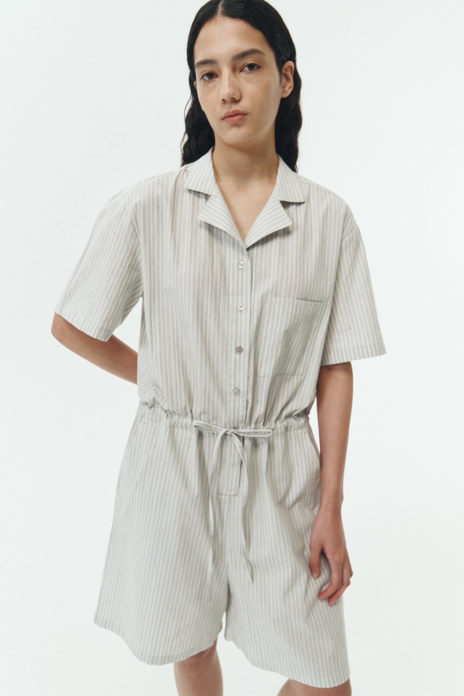 Emma Jumpsuit in stripe, short-sleeve cotton jumpsuit with camp collar, front buttons, drawstring waist, and multiple pockets.