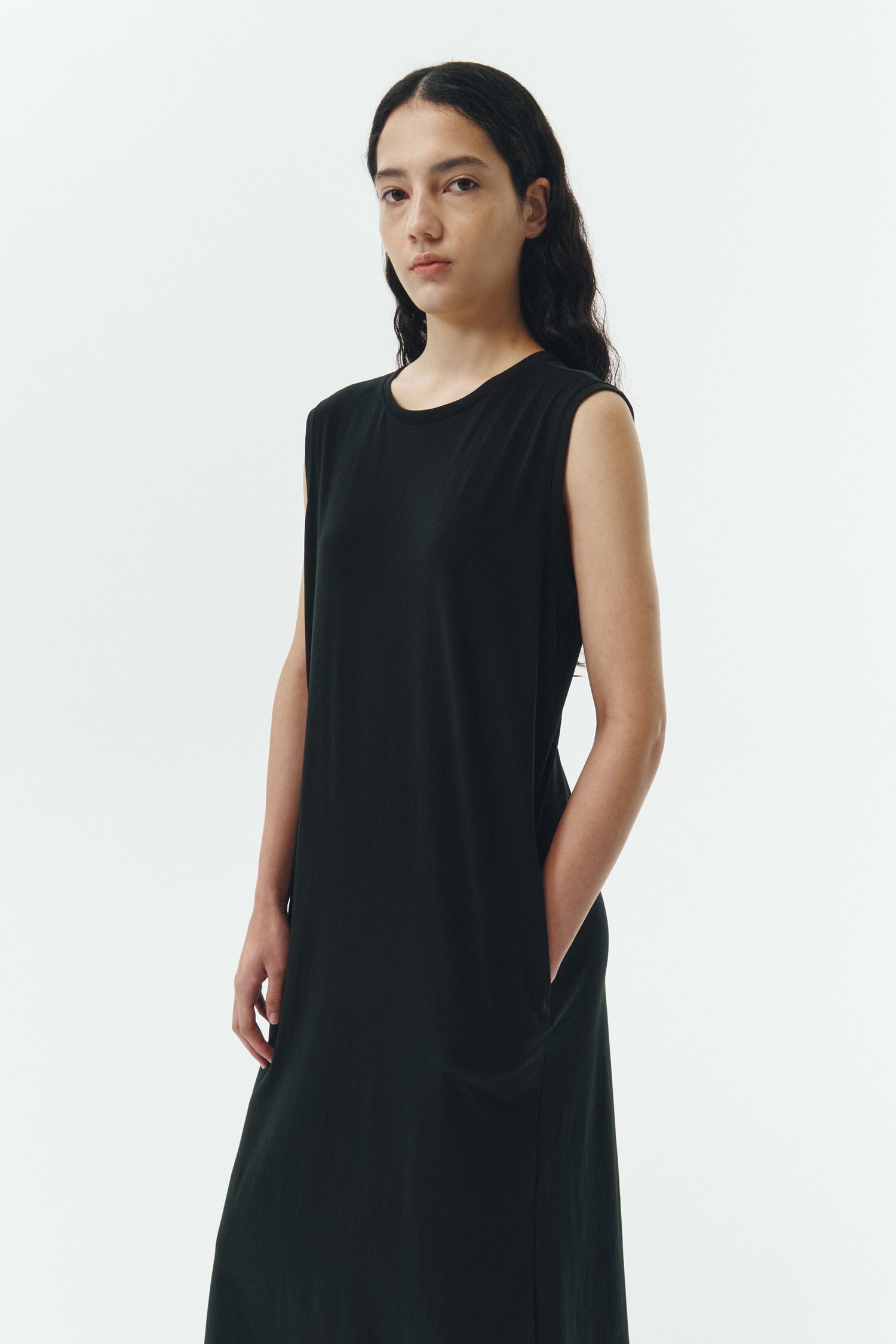 Jade Dress in black, a sleeveless knit cotton midi dress with side pockets, designed for breathable summer comfort
