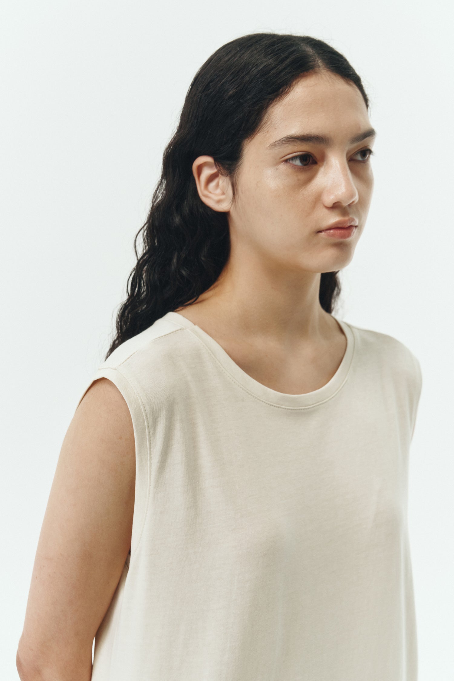 Jade Dress in cream, a sleeveless knit cotton midi dress with side pockets, designed for breathable summer comfort