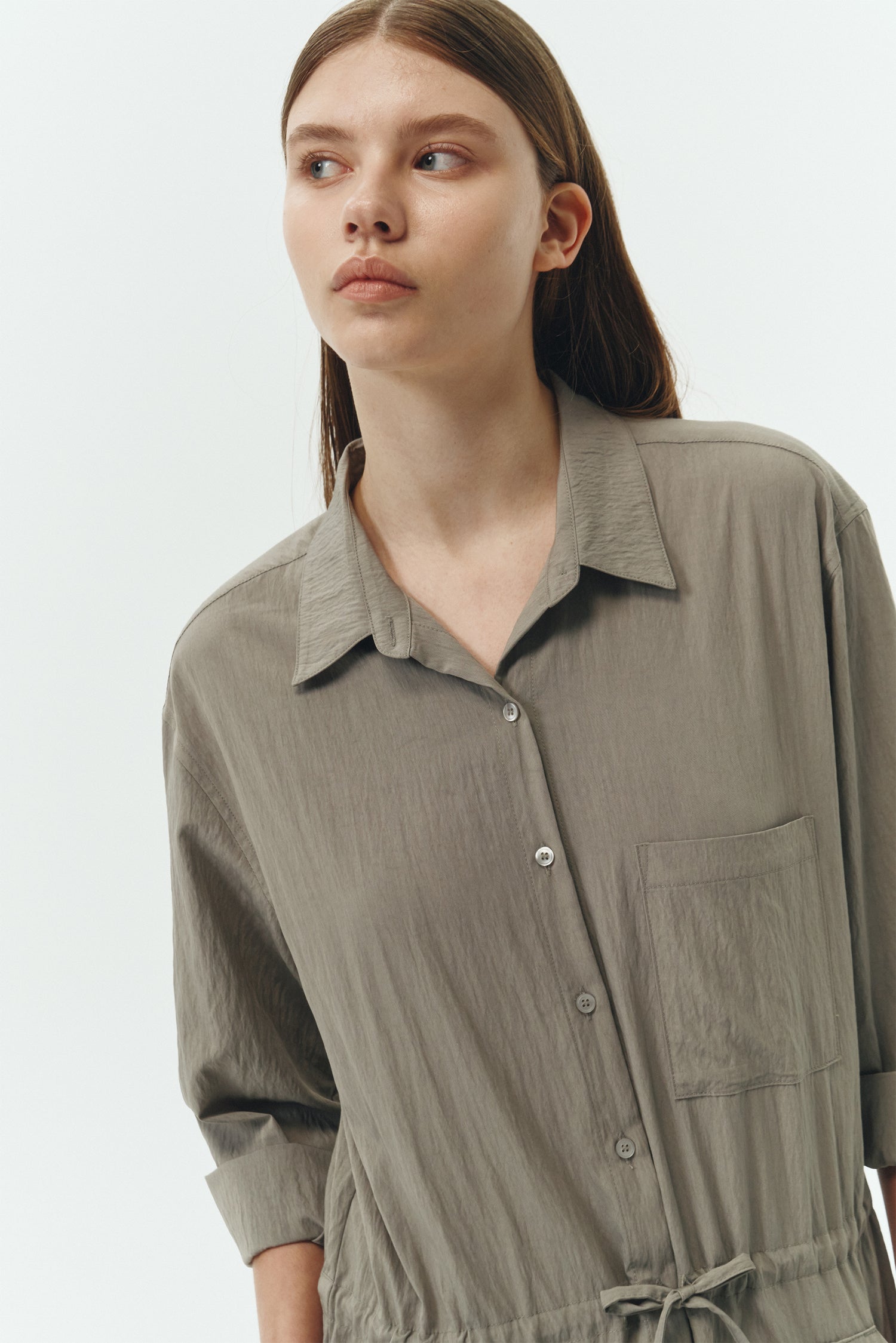 Saige Jumpsuit in khaki gray, long-sleeve rayon blend jumpsuit with point collar, front button closure, drawstring waist, and patch pockets.