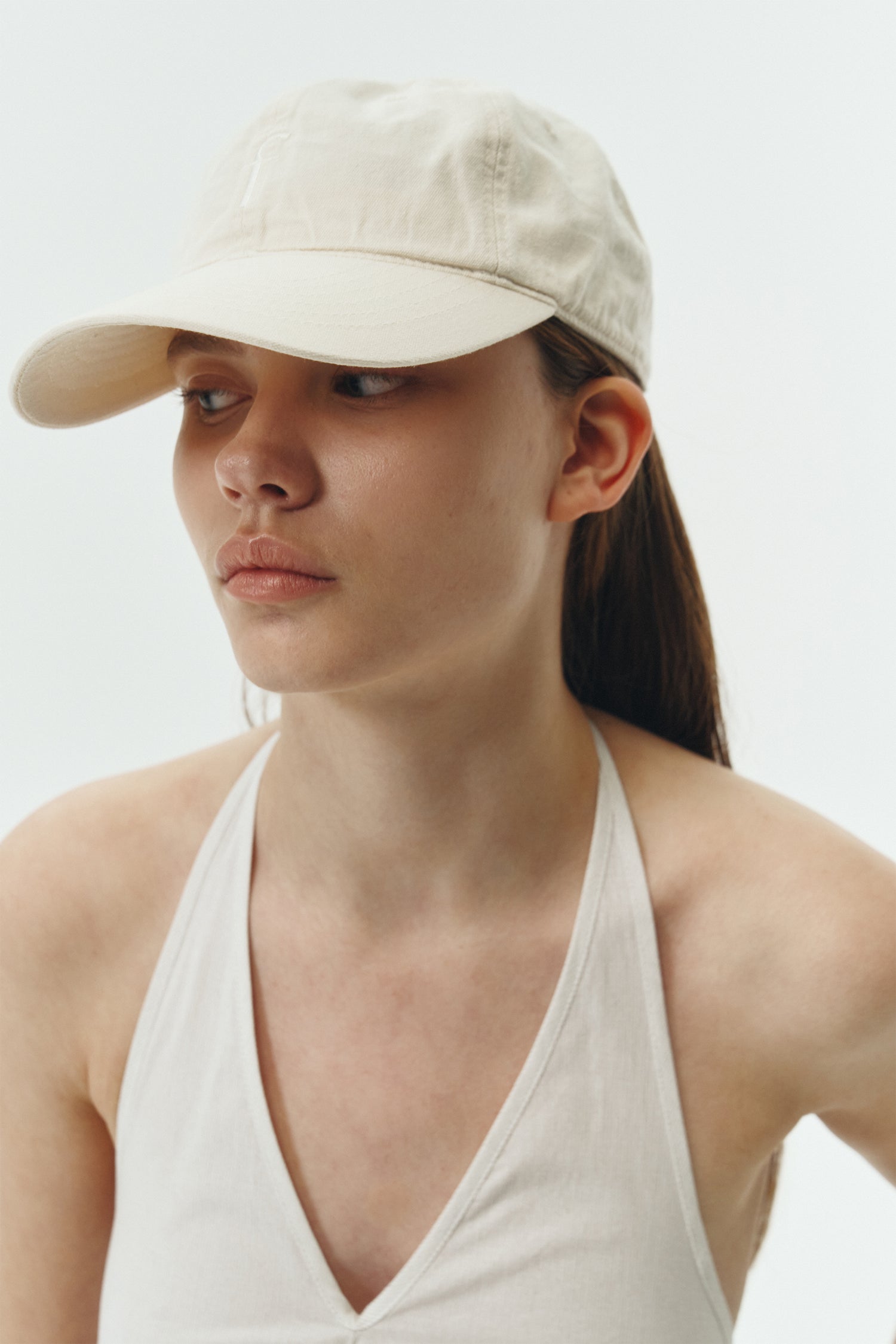 Steva Oxford Cap in cream, made from soft washed cotton with a front embroidered logo and adjustable buckle strap, designed for a casual everyday look