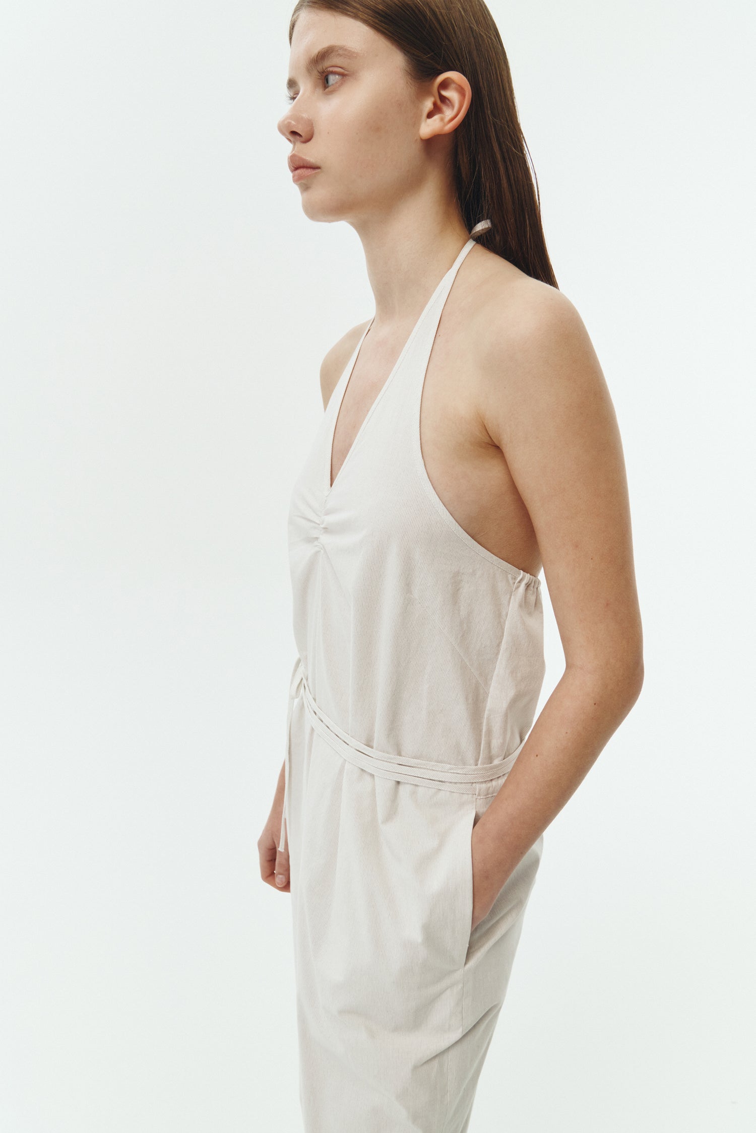 Daisy Jumpsuit in stripe, sleeveless linen blend jumpsuit with adjustable halterneck, open back, straight-leg silhouette, and relaxed fit.