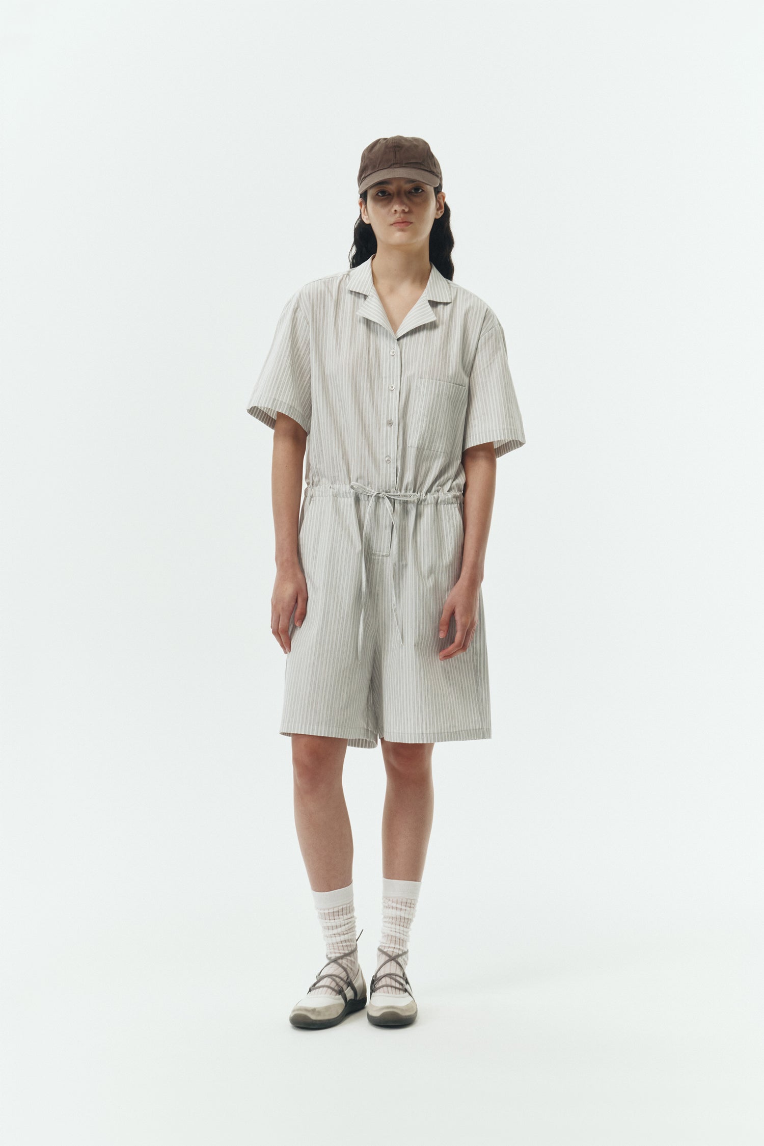 Emma Jumpsuit in stripe, short-sleeve cotton jumpsuit with camp collar, front buttons, drawstring waist, and multiple pockets.