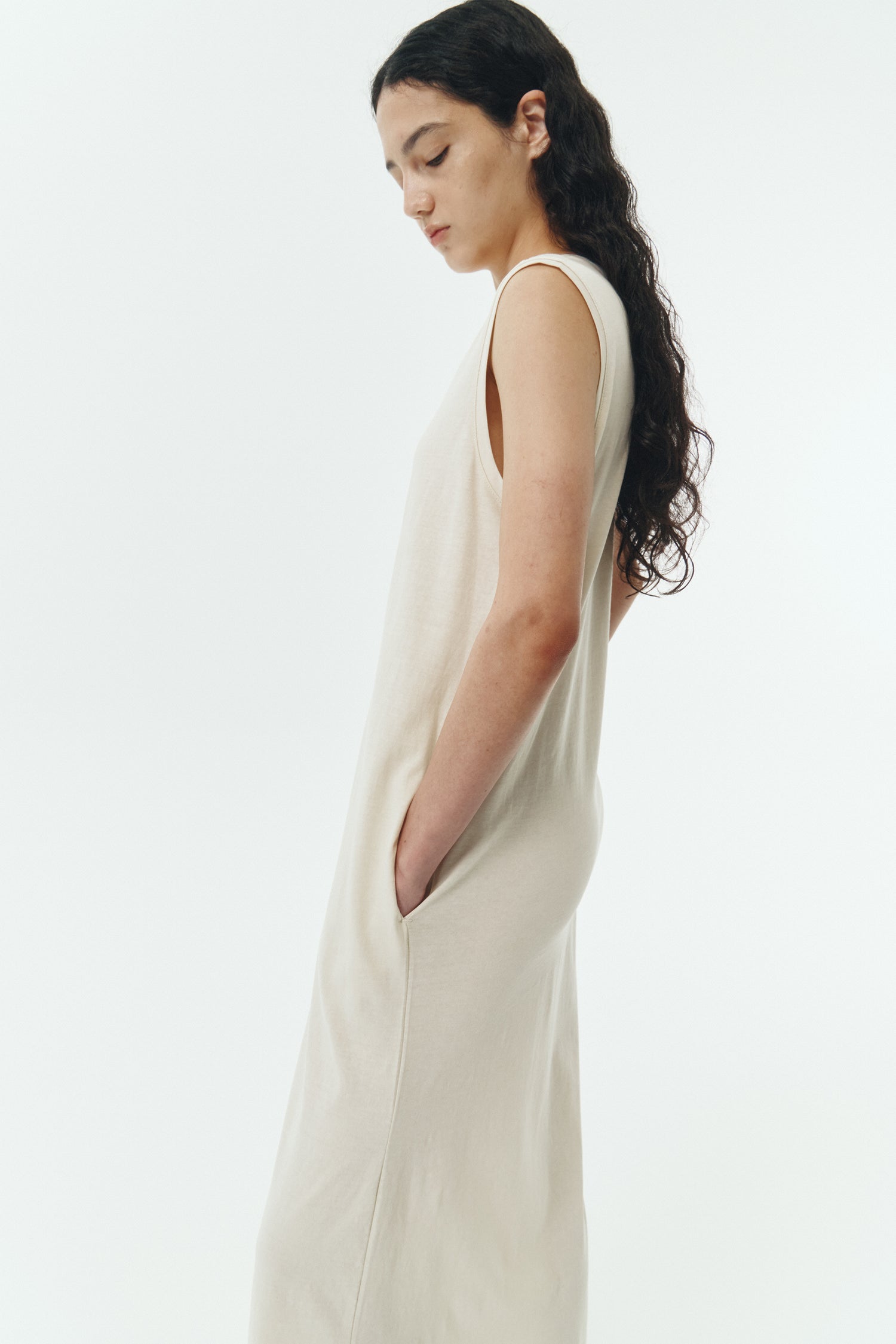 Jade Dress in cream, a sleeveless knit cotton midi dress with side pockets, designed for breathable summer comfort