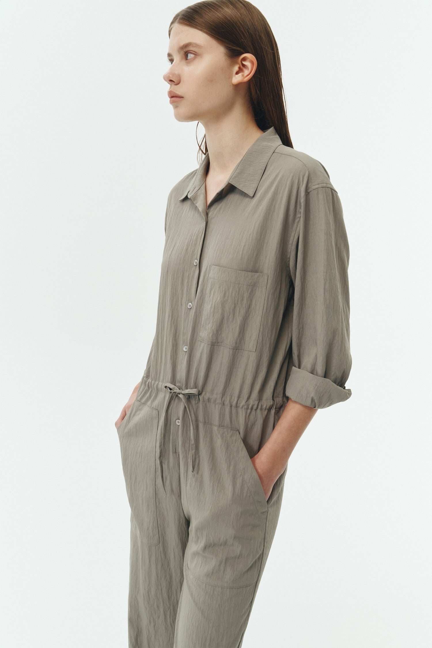 Saige Jumpsuit in khaki gray, long-sleeve rayon blend jumpsuit with point collar, front button closure, drawstring waist, and patch pockets.