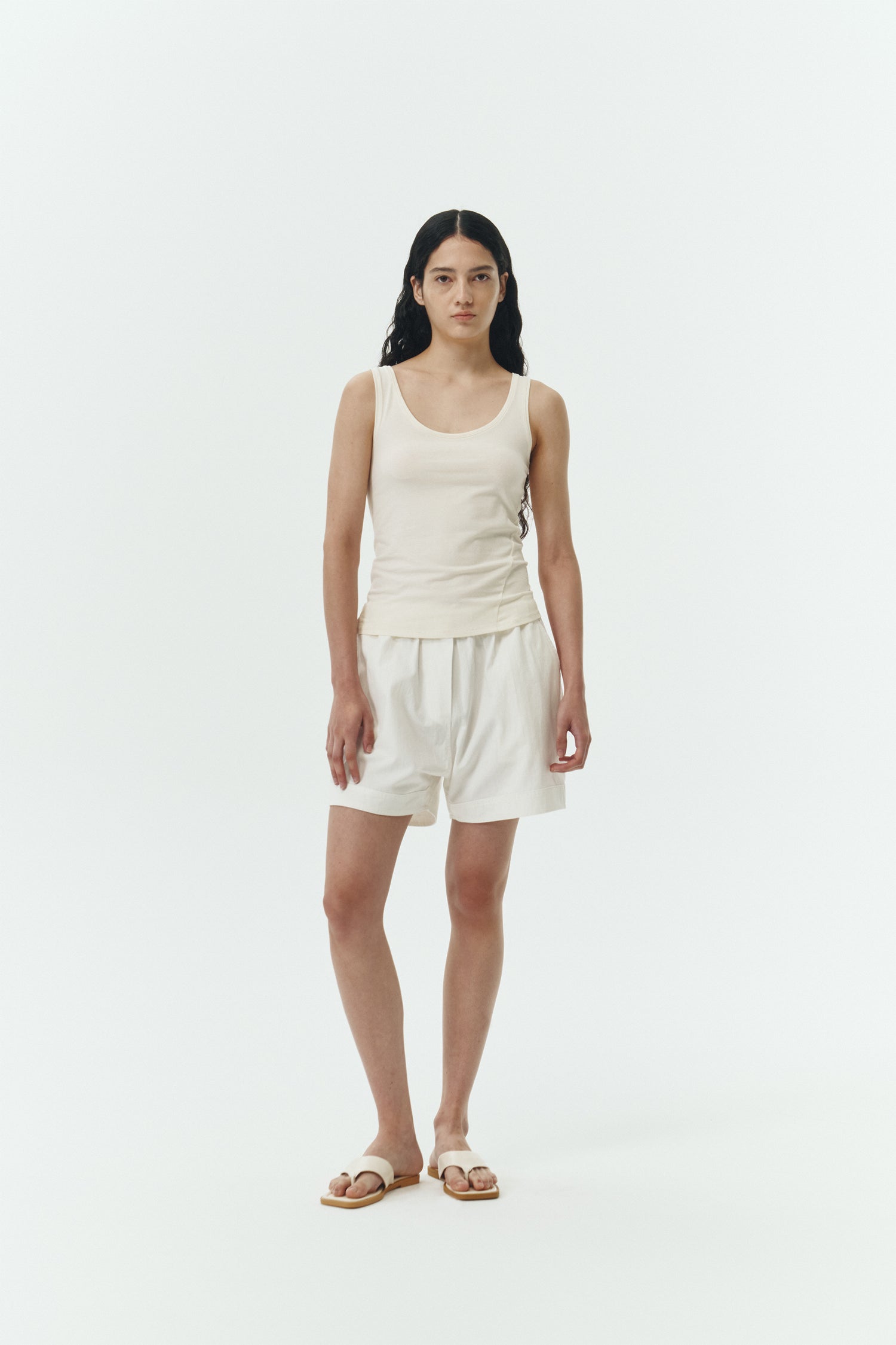 Zoe Tank Top in cream, slim-fit stretch cotton tank with scooped neckline and diagonal seam detail for a sleek and minimal silhouette.