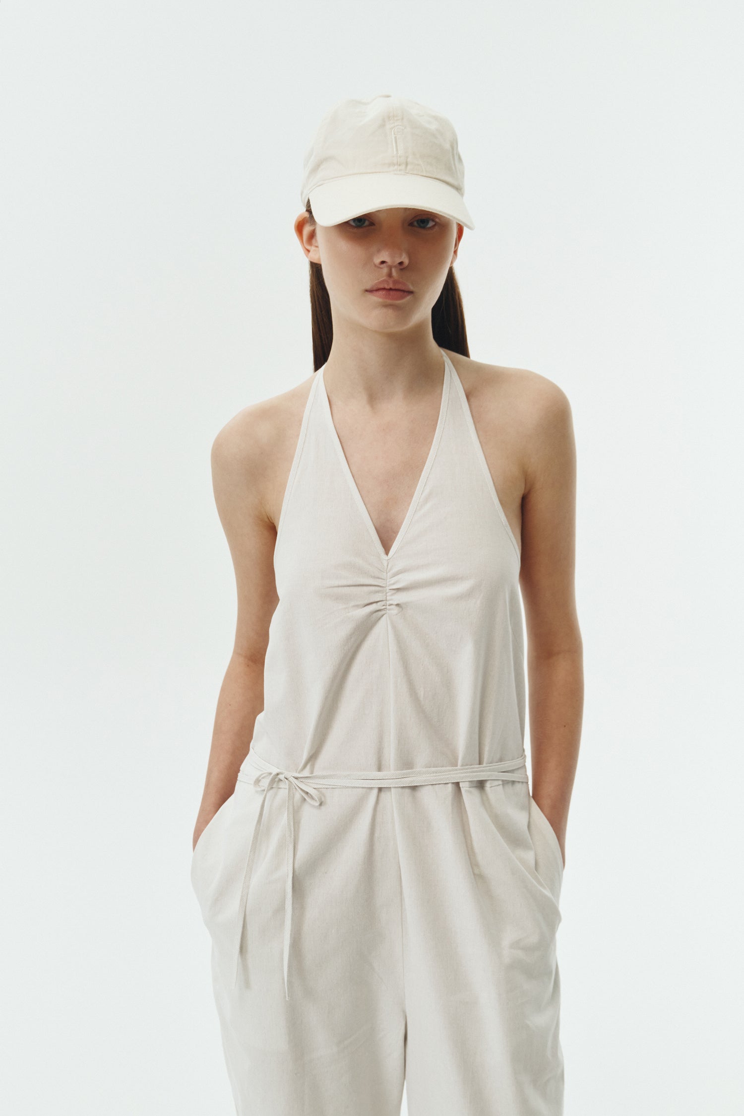 Daisy Jumpsuit in stripe, sleeveless linen blend jumpsuit with adjustable halterneck, open back, straight-leg silhouette, and relaxed fit.