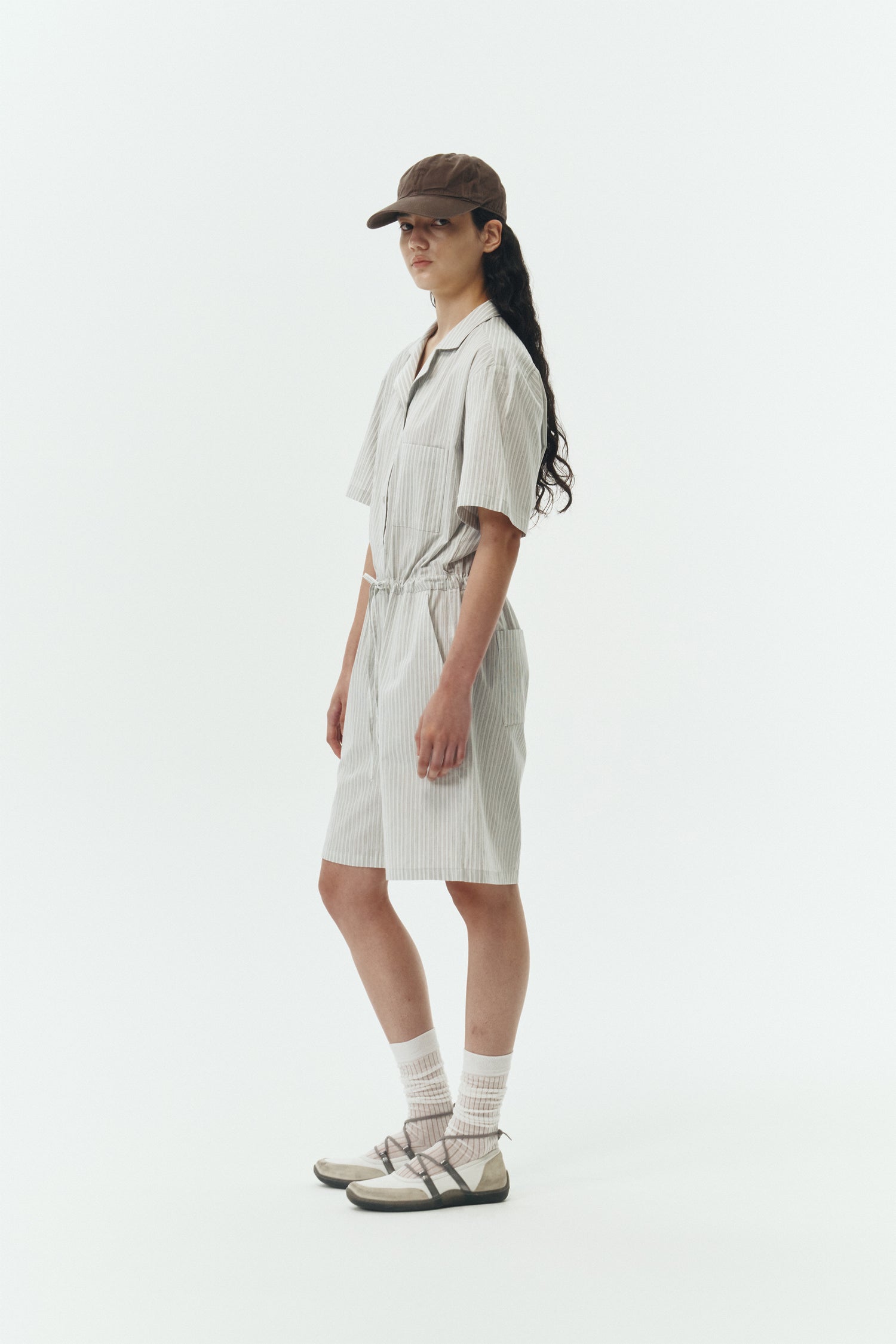 Emma Jumpsuit in stripe, short-sleeve cotton jumpsuit with camp collar, front buttons, drawstring waist, and multiple pockets.