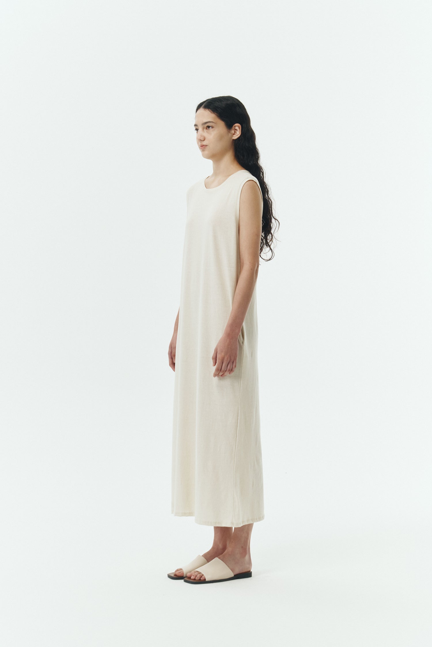 Jade Dress in cream, a sleeveless knit cotton midi dress with side pockets, designed for breathable summer comfort