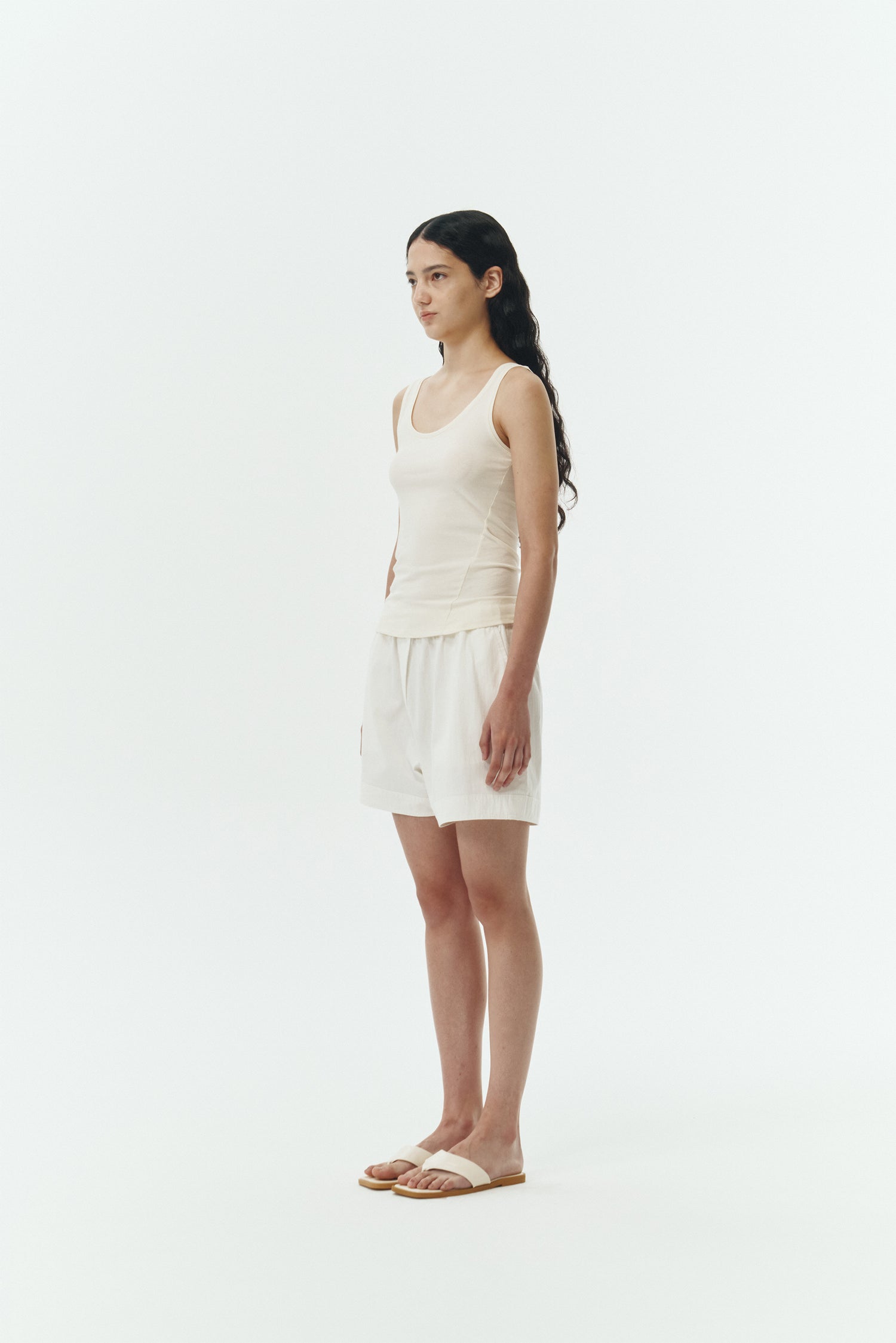 Zoe Tank Top in cream, slim-fit stretch cotton tank with scooped neckline and diagonal seam detail for a sleek and minimal silhouette.