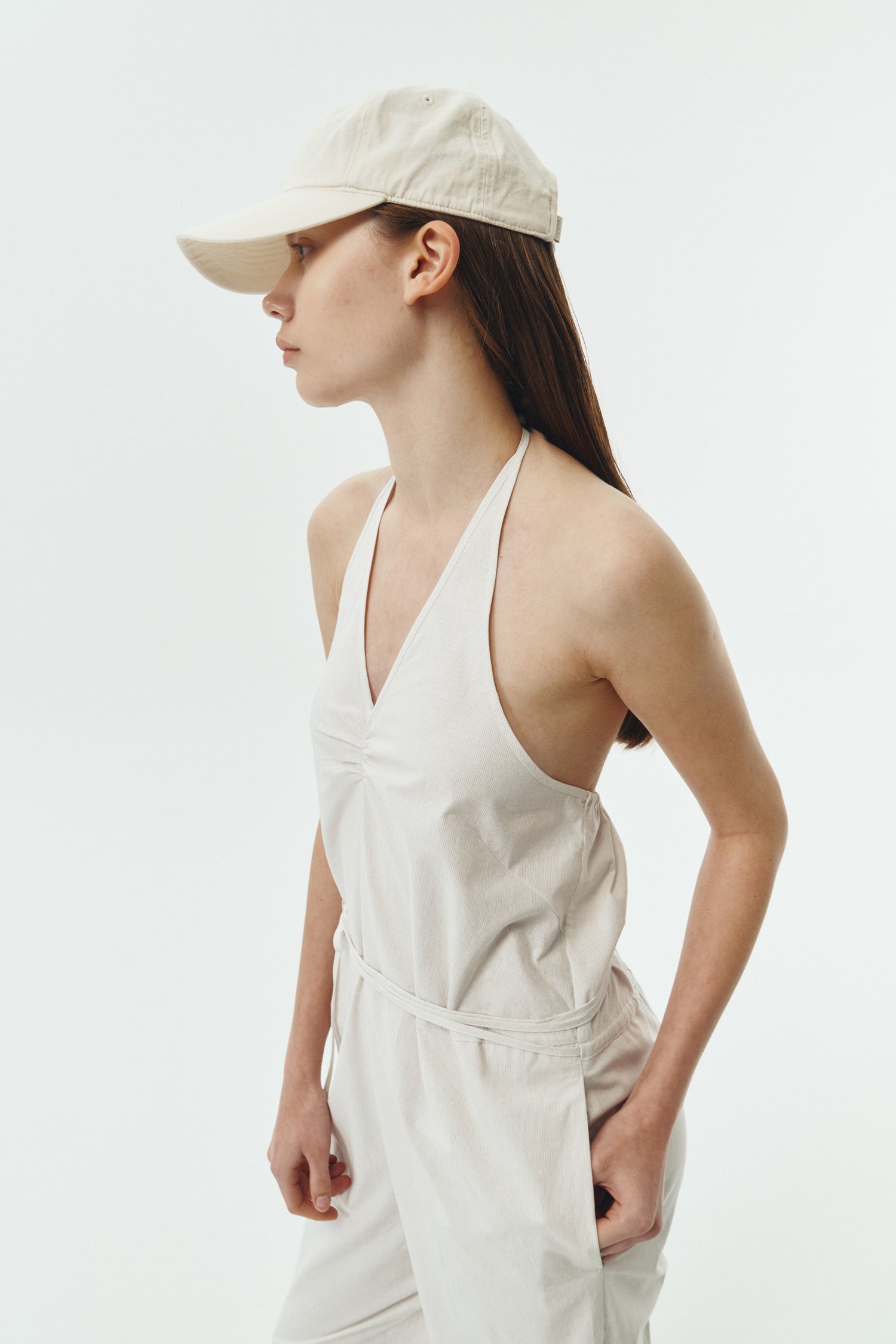 Daisy Jumpsuit in stripe, sleeveless linen blend jumpsuit with adjustable halterneck, open back, straight-leg silhouette, and relaxed fit.