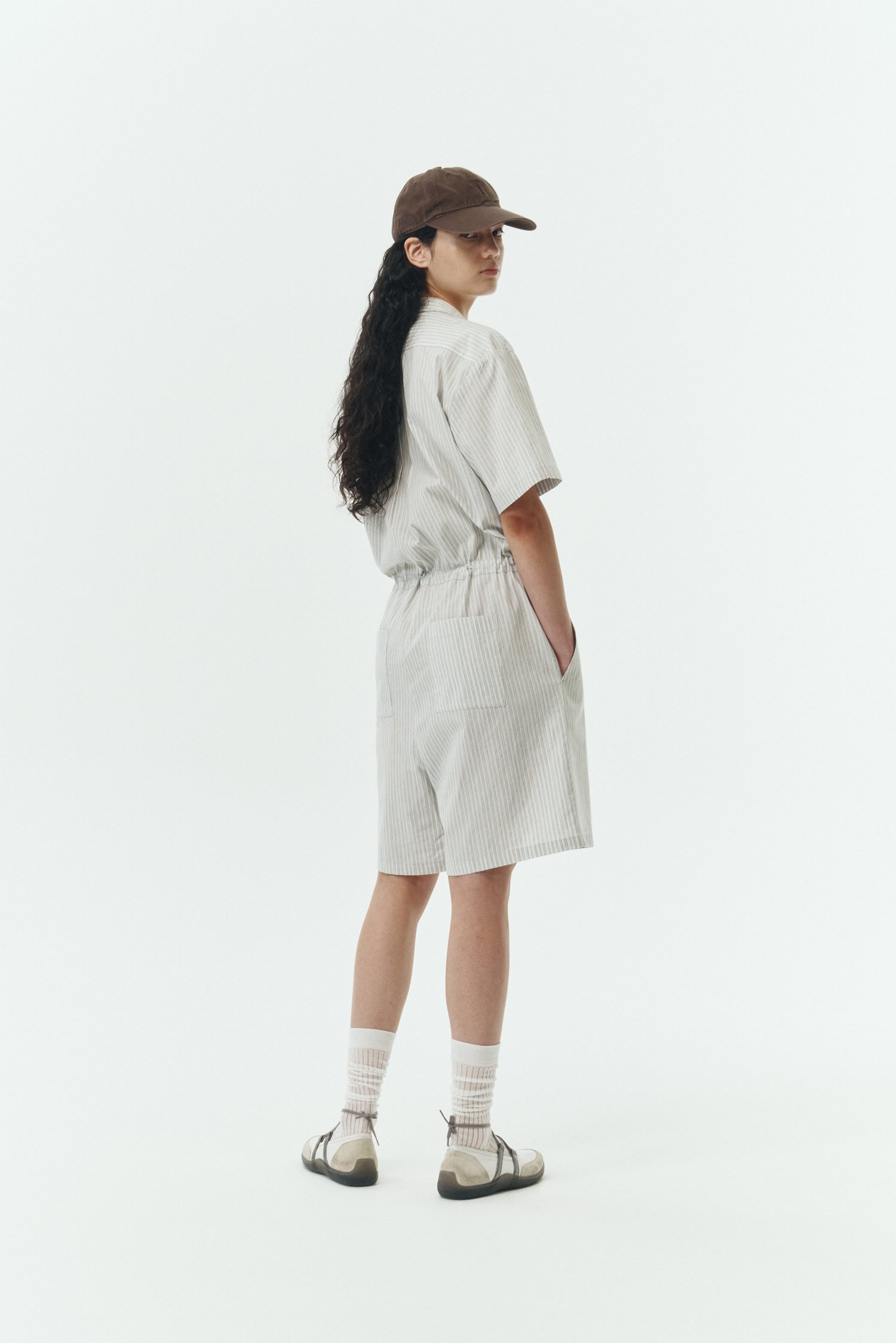 Emma Jumpsuit in stripe, short-sleeve cotton jumpsuit with camp collar, front buttons, drawstring waist, and multiple pockets.