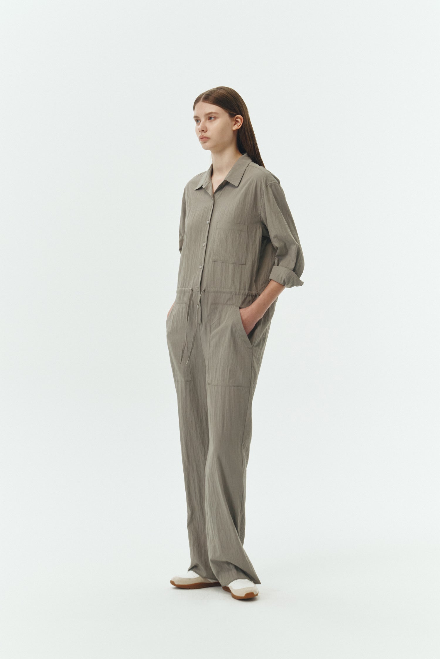 Saige Jumpsuit in khaki gray, long-sleeve rayon blend jumpsuit with point collar, front button closure, drawstring waist, and patch pockets.