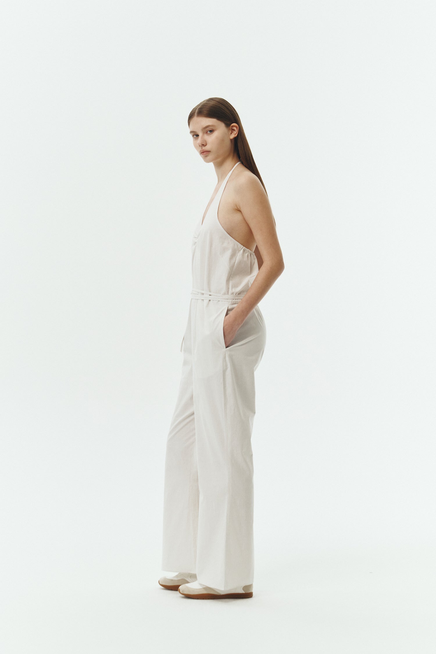 Daisy Jumpsuit in stripe, sleeveless linen blend jumpsuit with adjustable halterneck, open back, straight-leg silhouette, and relaxed fit.