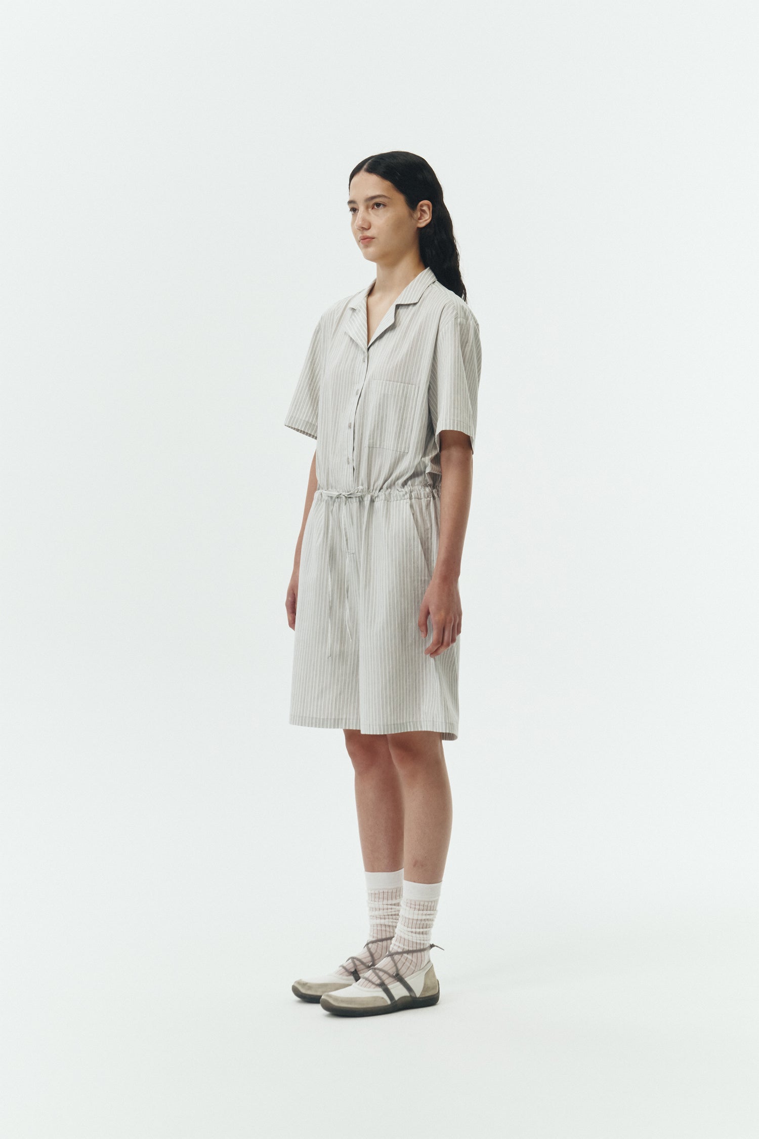 Emma Jumpsuit in stripe, short-sleeve cotton jumpsuit with camp collar, front buttons, drawstring waist, and multiple pockets.