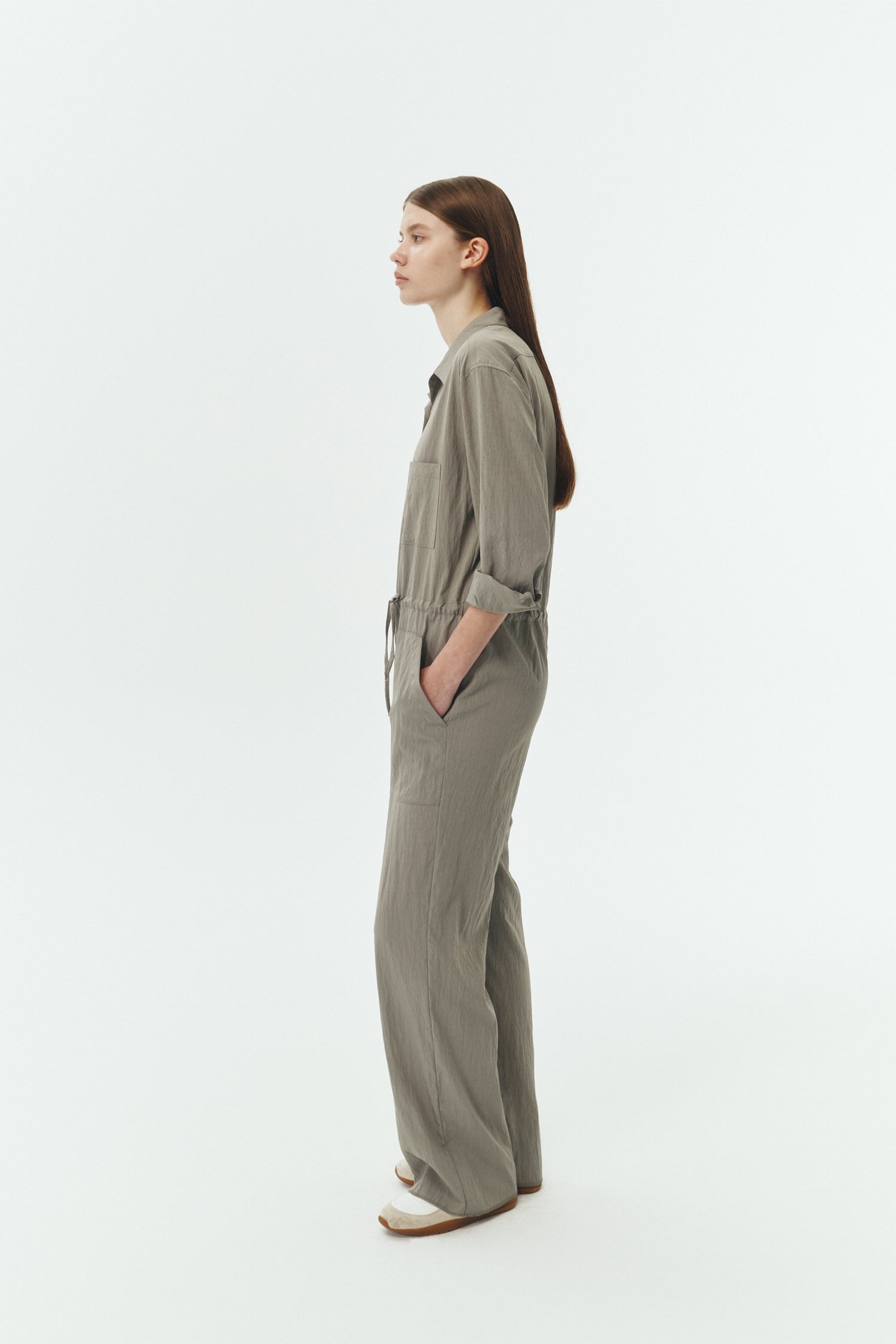 Saige Jumpsuit in khaki gray, long-sleeve rayon blend jumpsuit with point collar, front button closure, drawstring waist, and patch pockets.