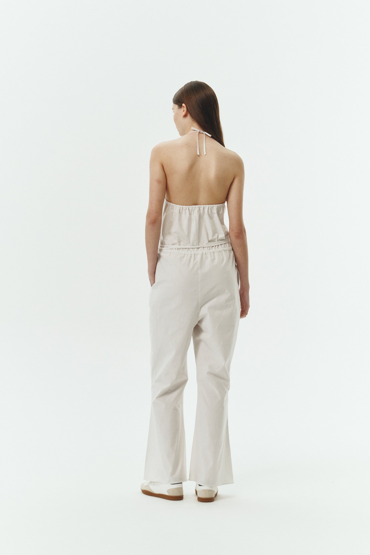 Daisy Jumpsuit in stripe, sleeveless linen blend jumpsuit with adjustable halterneck, open back, straight-leg silhouette, and relaxed fit.