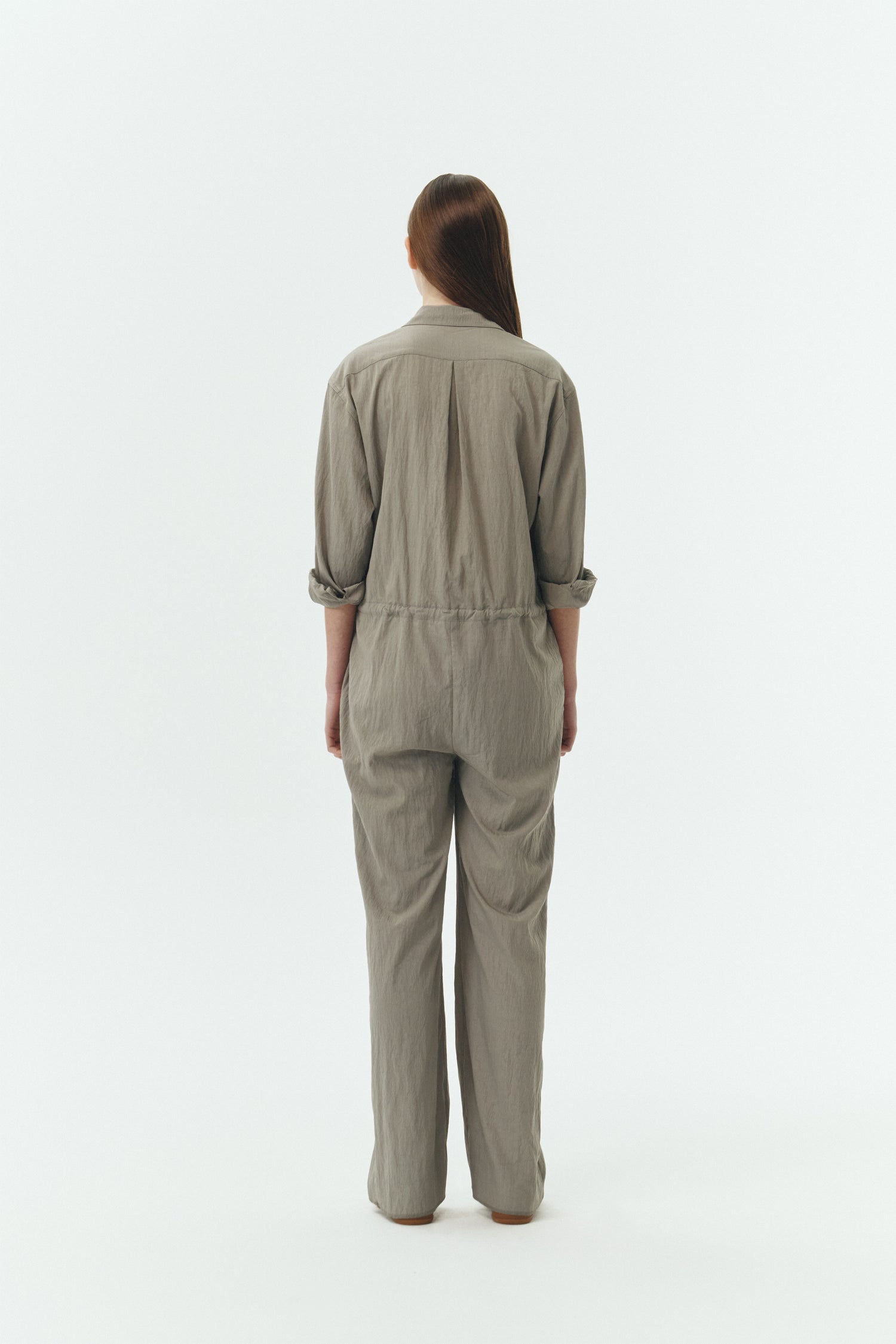 Saige Jumpsuit in khaki gray, long-sleeve rayon blend jumpsuit with point collar, front button closure, drawstring waist, and patch pockets.