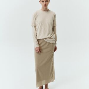 Amelia Skirt in sand, a lightweight cotton midi skirt with inner drawstring waist, hidden side pockets, lined layers, raw-edge hem, and a center back slit for ease and movement