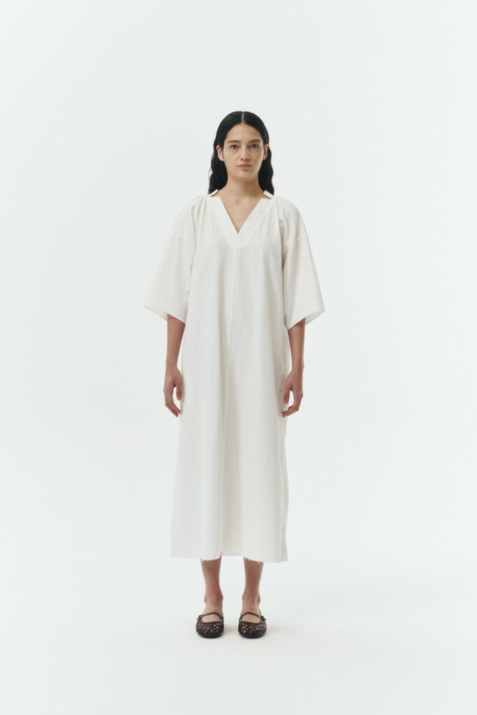 Charlotte Dress in white stripe, V-neck summer maxi dress in a lightweight linen-rayon blend with drop shoulders, hidden side pockets, raw edge hem, and a relaxed fit.