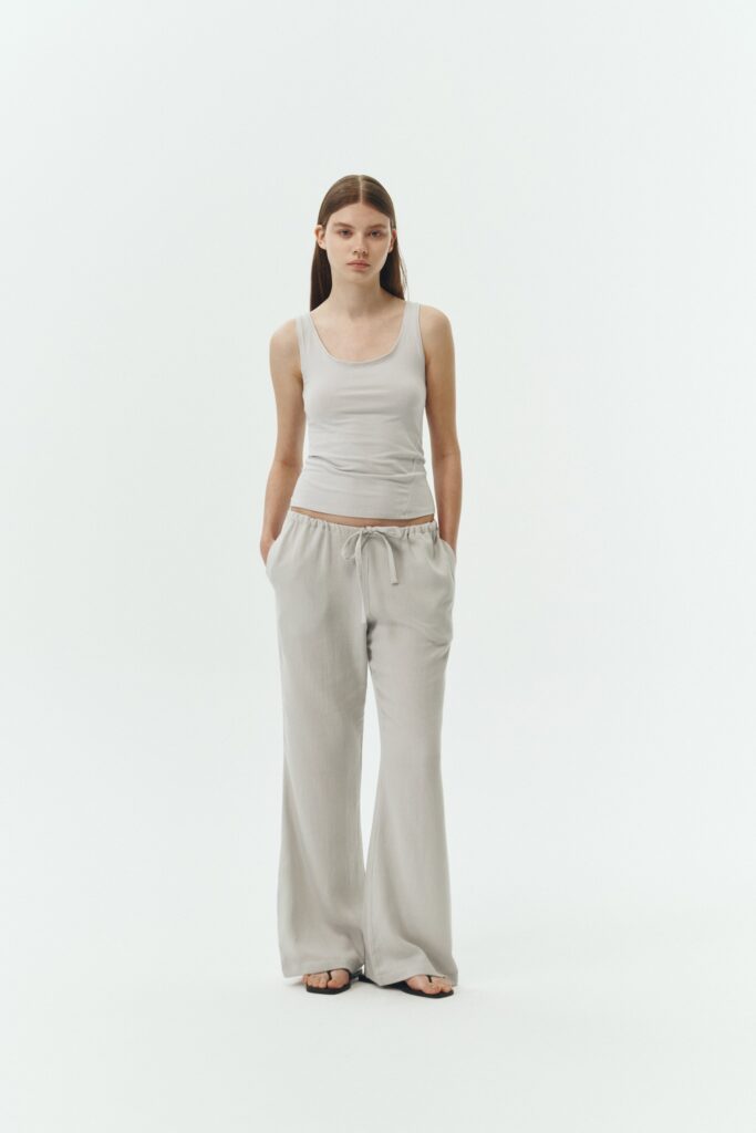 Chloe Pants in cloud gray, lightweight cotton pants with a drawstring waist, side pockets, and a flared bottom, relaxed fit for effortless everyday wear